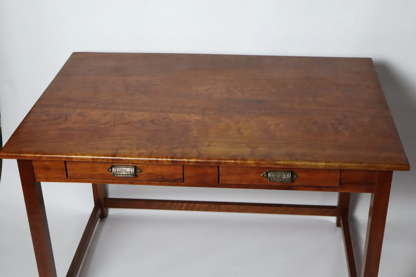 This Cherry Desk has been used every day for the past 15 years. All are handcrafted using traditional joinery methods. Desks like this can be made to any dimension that would fit your space. This desk has two drawers; it can be built with one or none