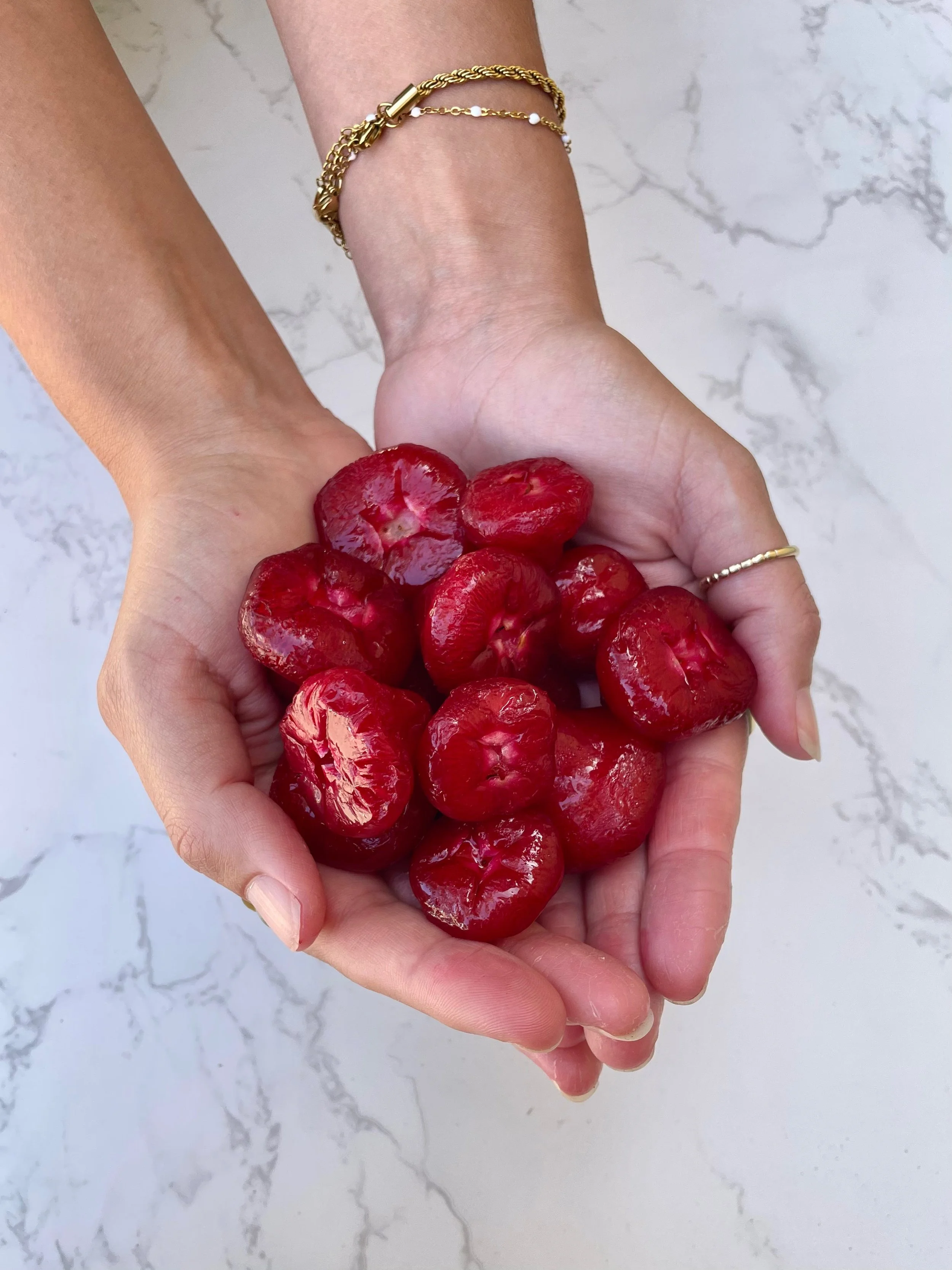 Native Rainforest Cherry/Water Apple bushfood, displayed freshly picked in hands