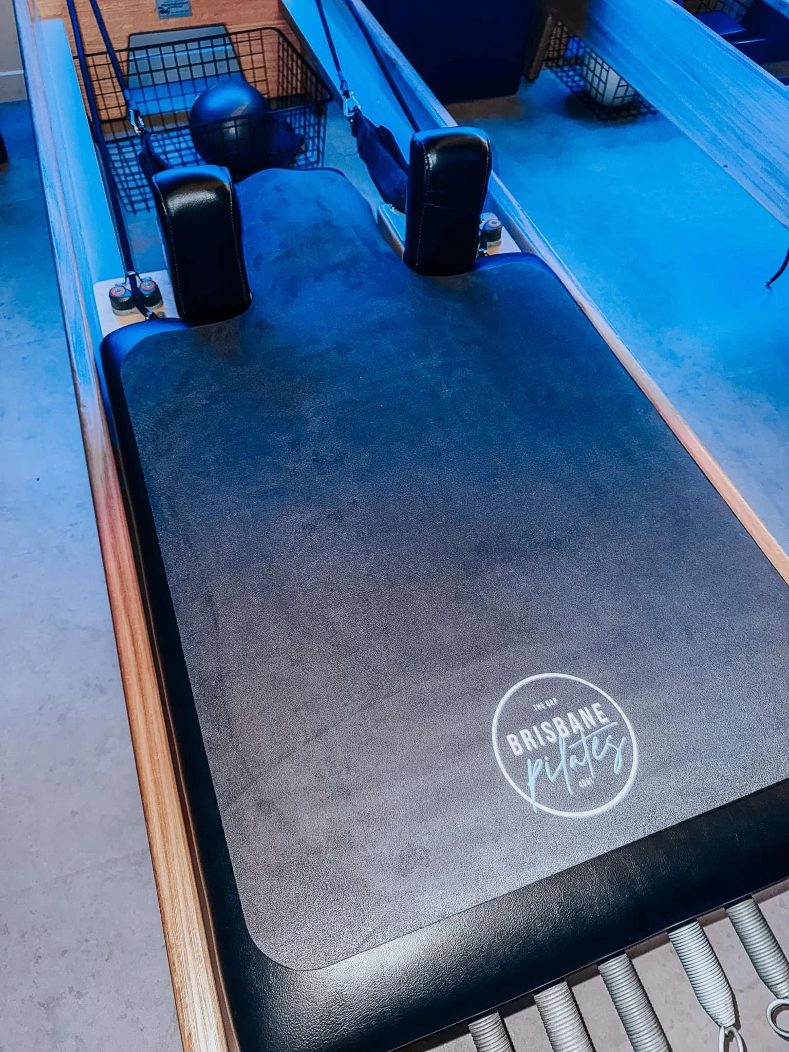 A foosball table with the logo 'Brisbane Play' on the surface, located in an indoor recreational area.