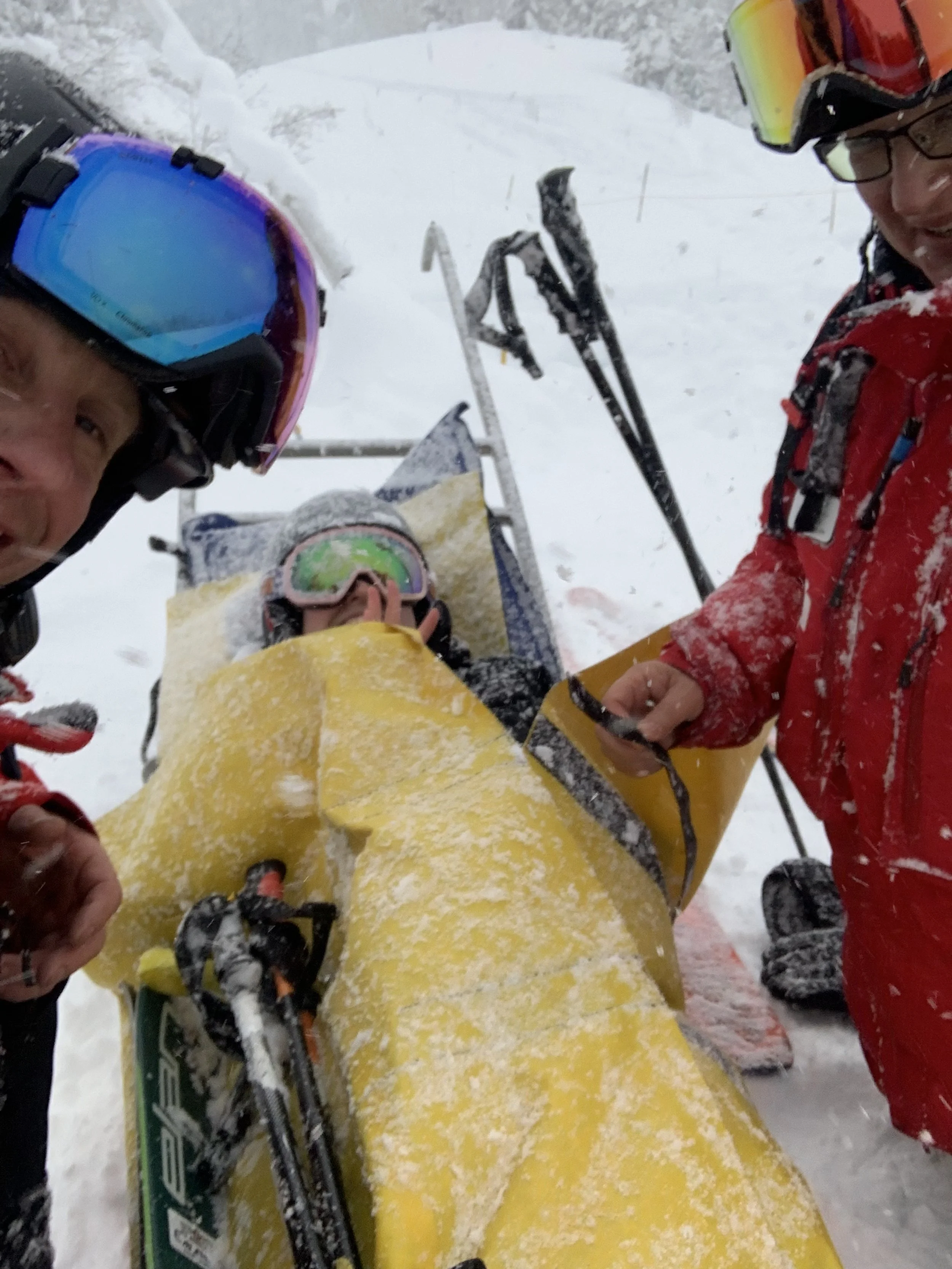 a person on a paramedic sled on a snowy mountain
