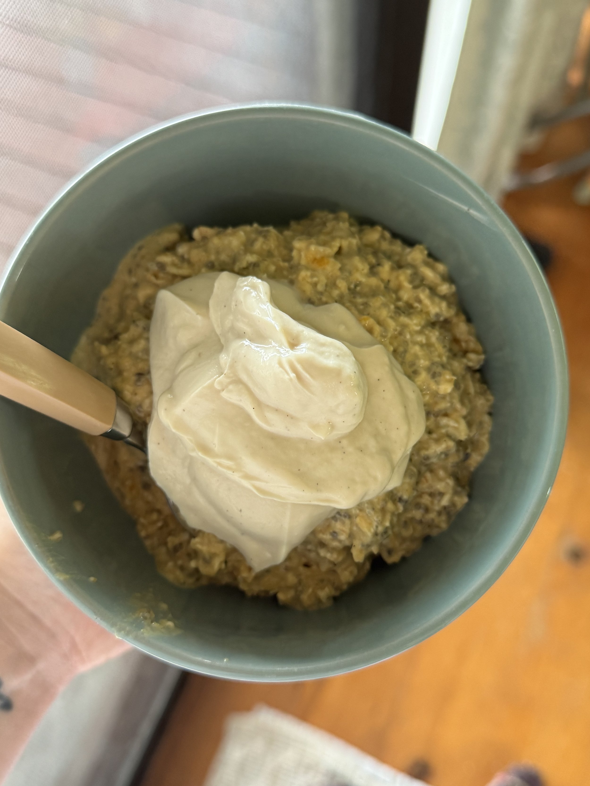 A green bowl with porridge in it