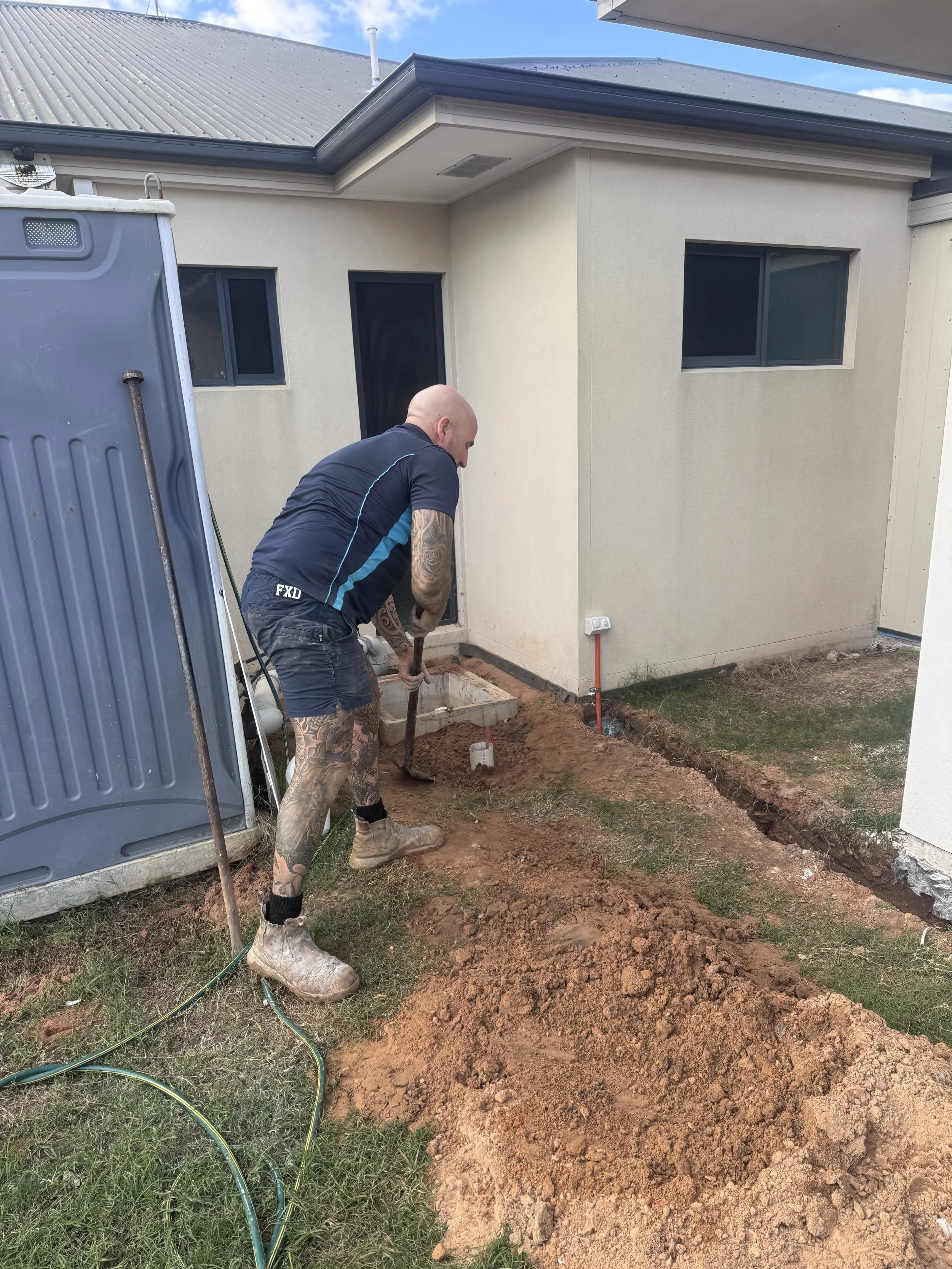 Plumber installing macerator preeminent plumbing services