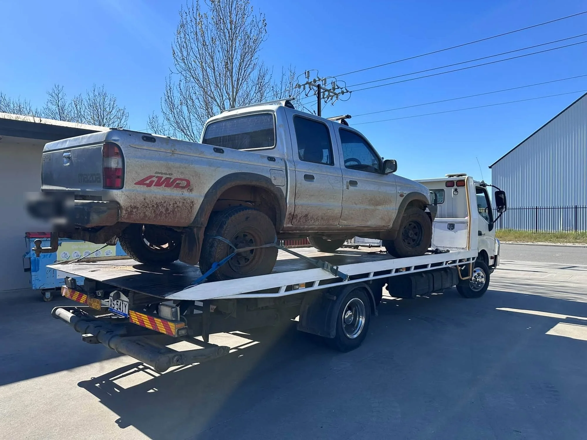 Cash for Cars Adelaide tilt tray picking up a muddy 4WD ute in Adelaide