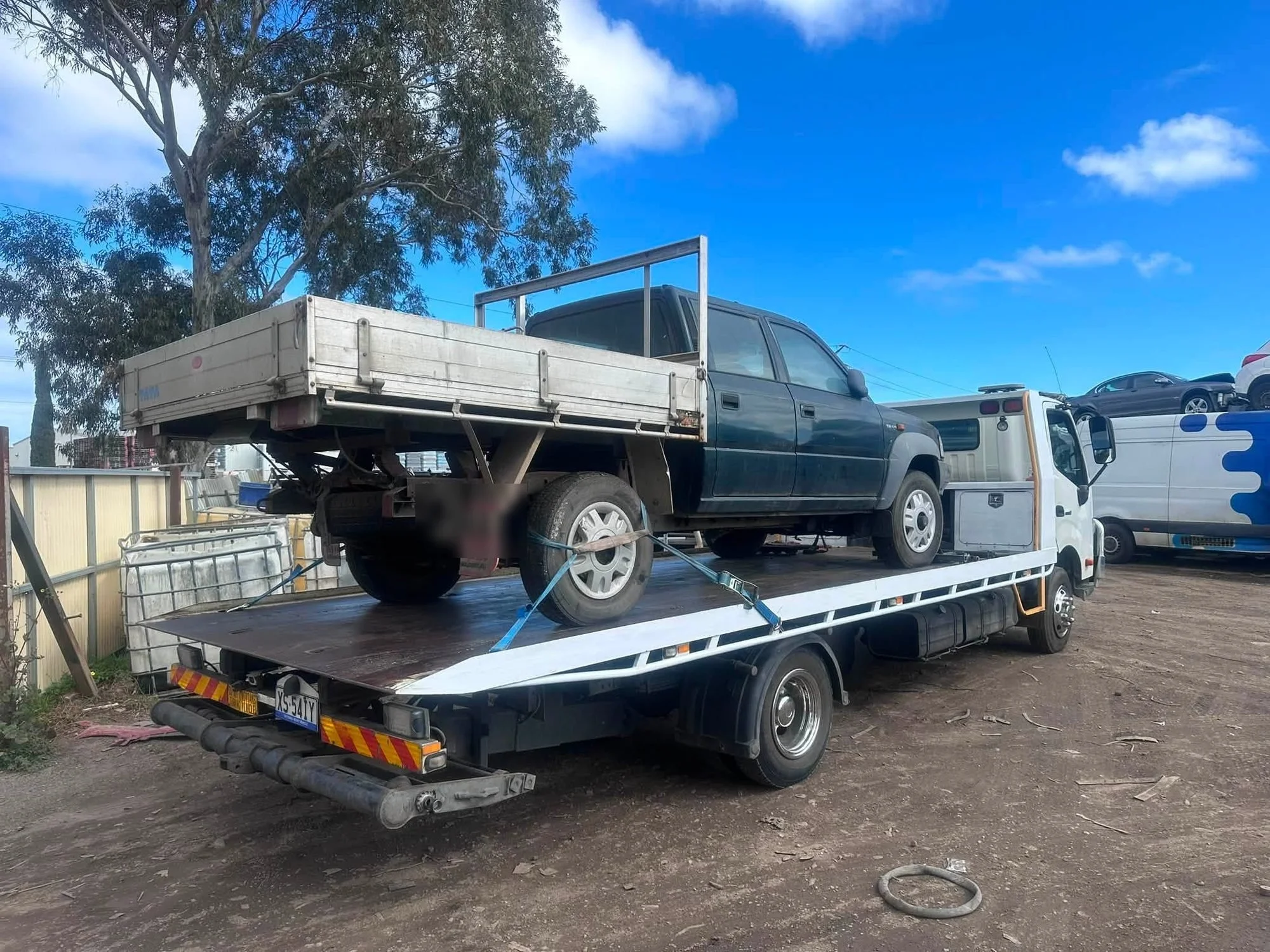Cash for Cars Adelaide tilt tray picking up a dark green dual-cab ute in Adelaide