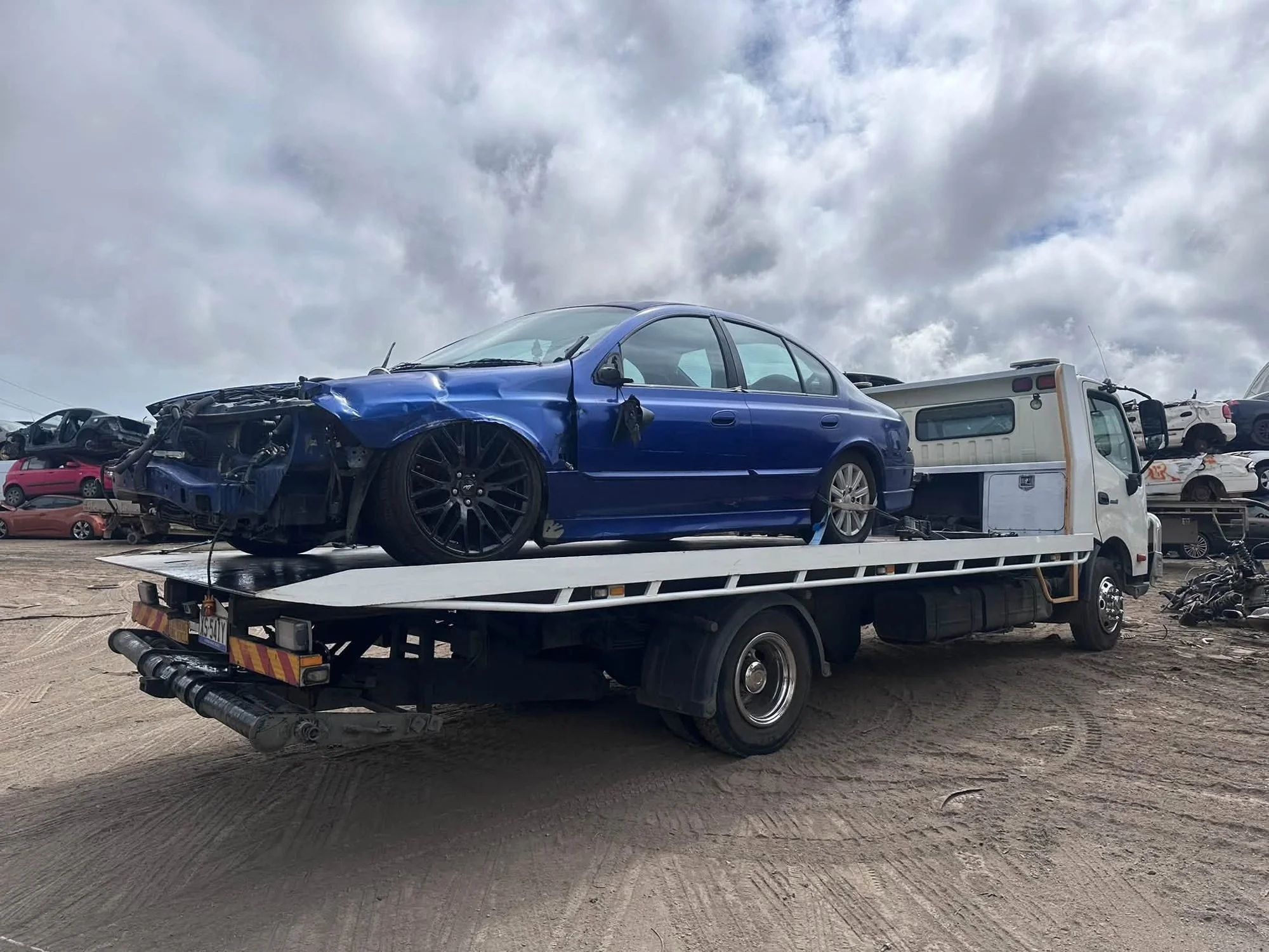 Cash for Cars Adelaide tilt tray picking up a crash-damaged Ford Falcon in Adelaide