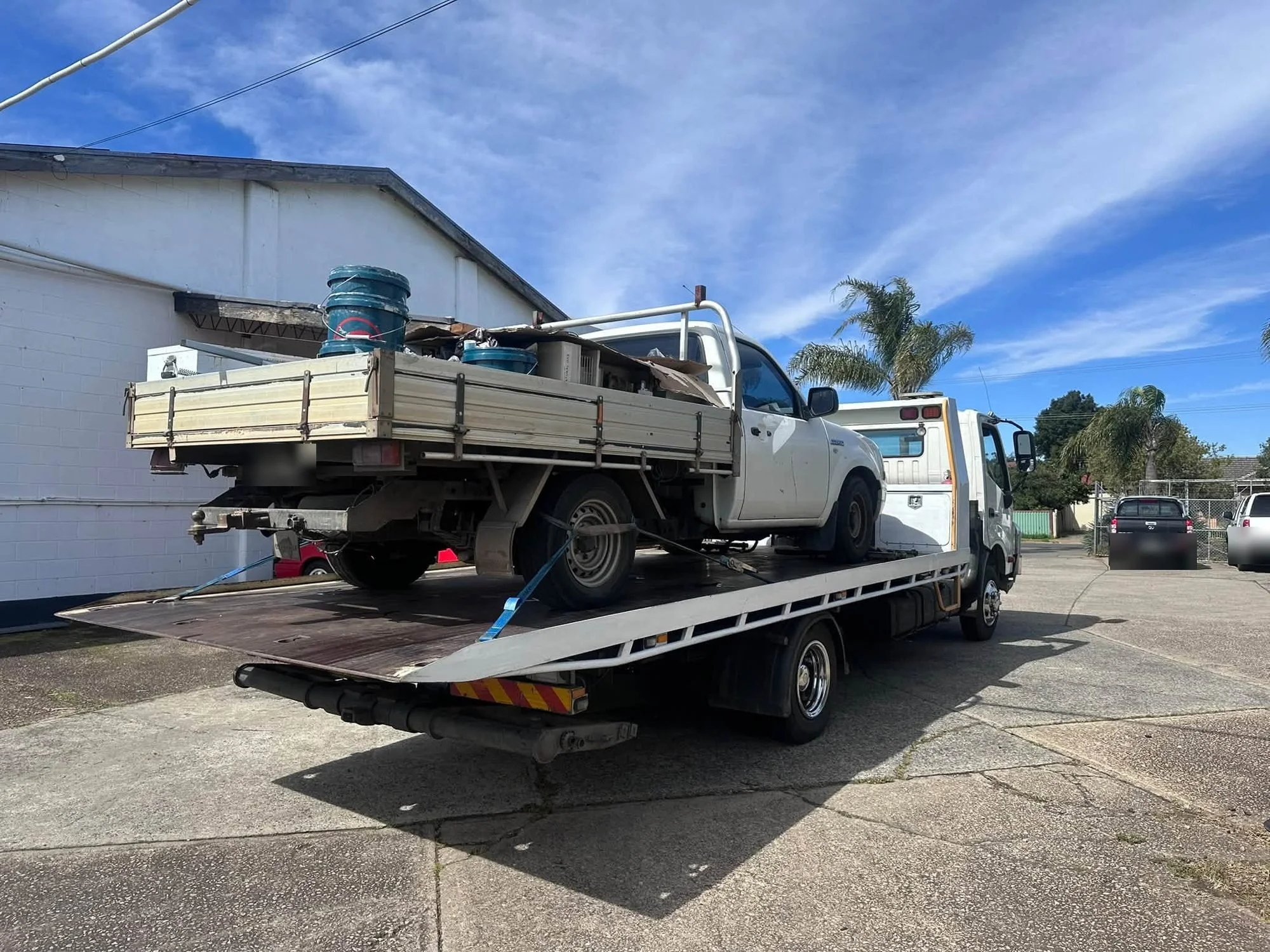 Cash for Cars Adelaide tilt tray picking up a white ute loaded with junk in Adelaide