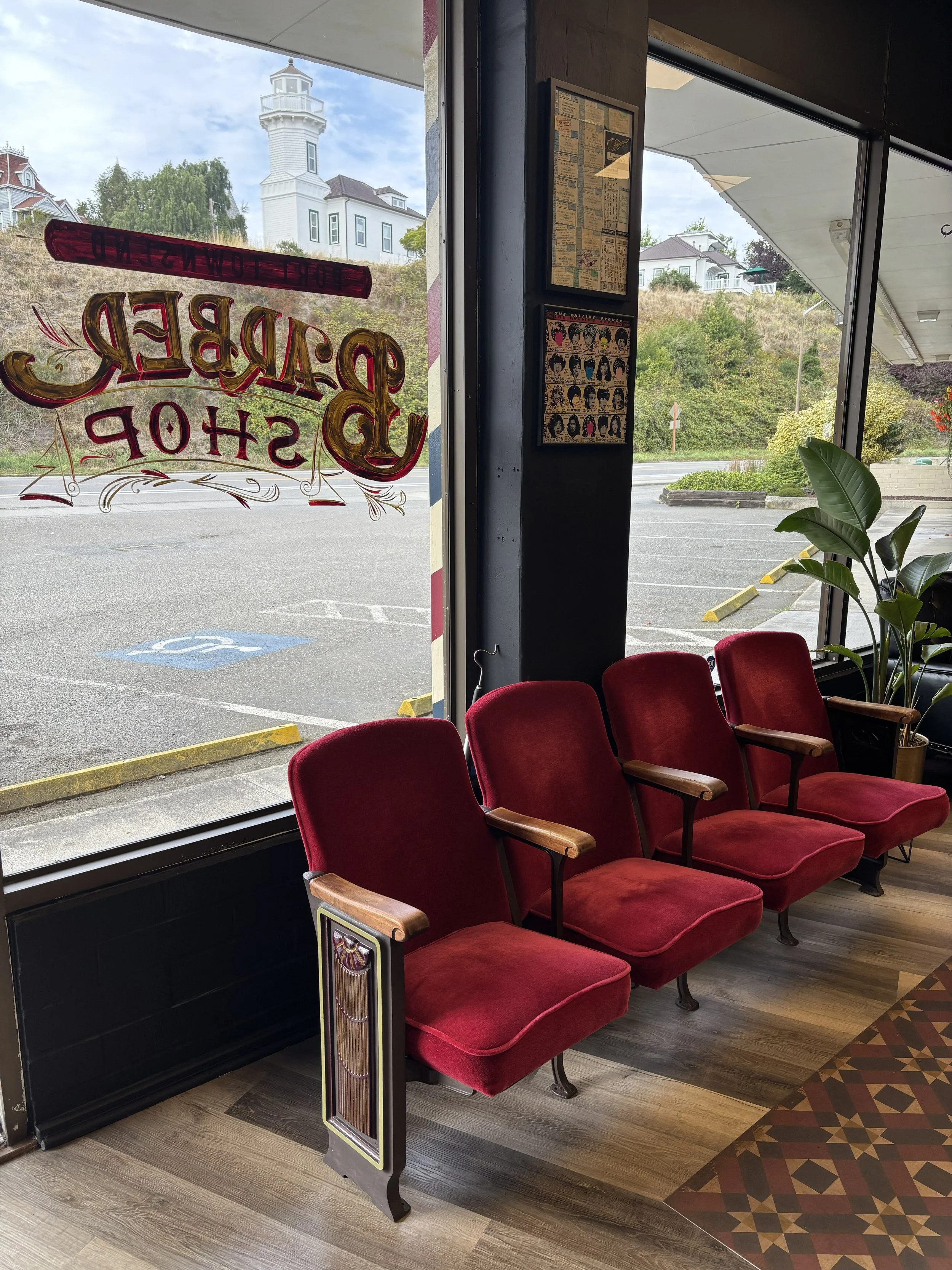 View of a lighthouse from the barber chair at Port Townsend Barbershop