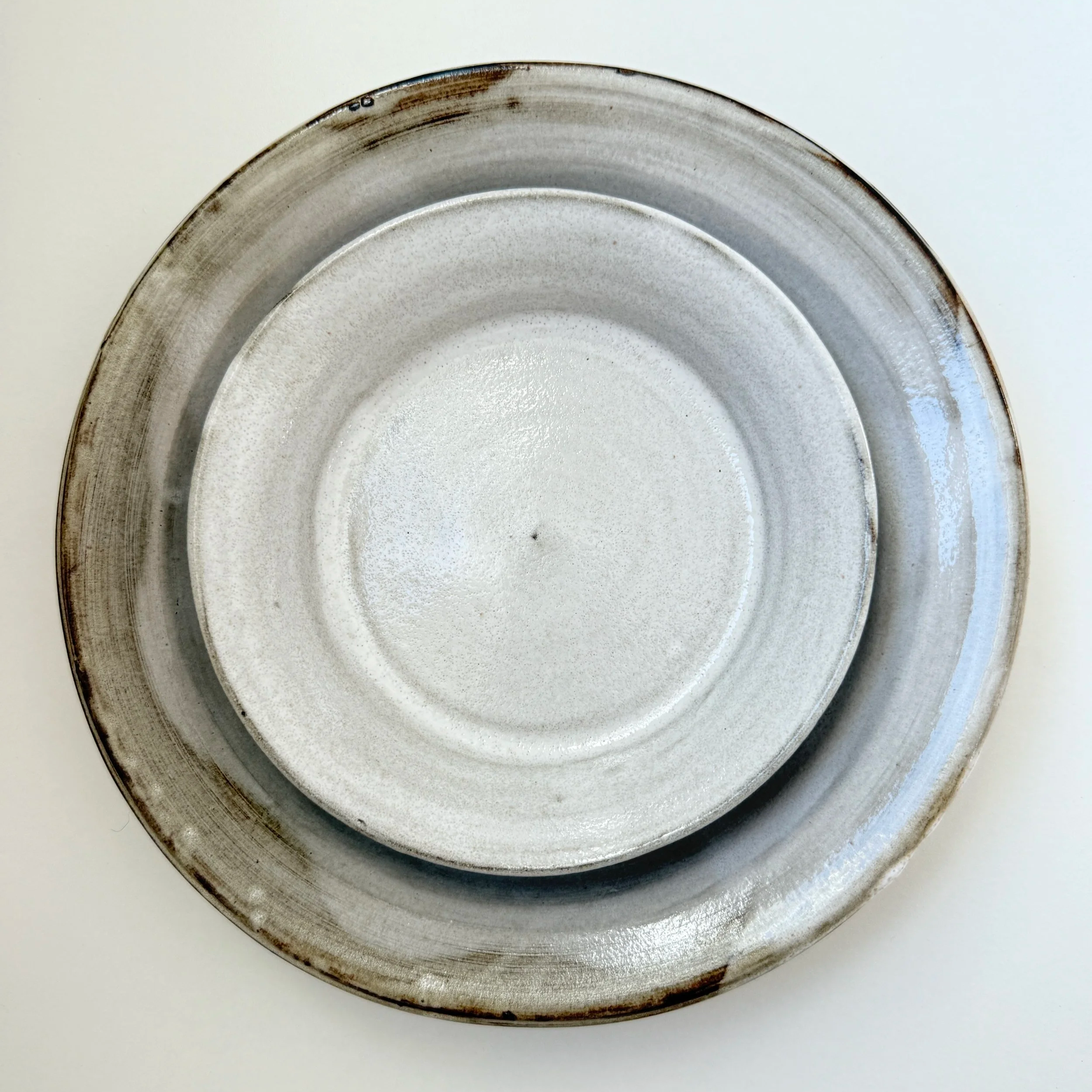 Ceramic mug with a rough, grayish texture, handle on the right, placed against a white background.