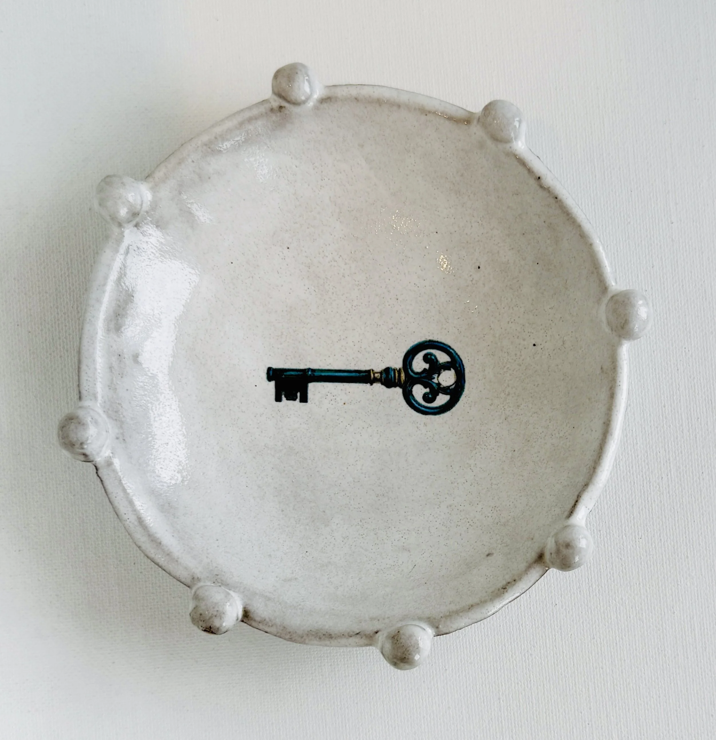 Ceramic mug with a rough, grayish texture, handle on the right, placed against a white background.