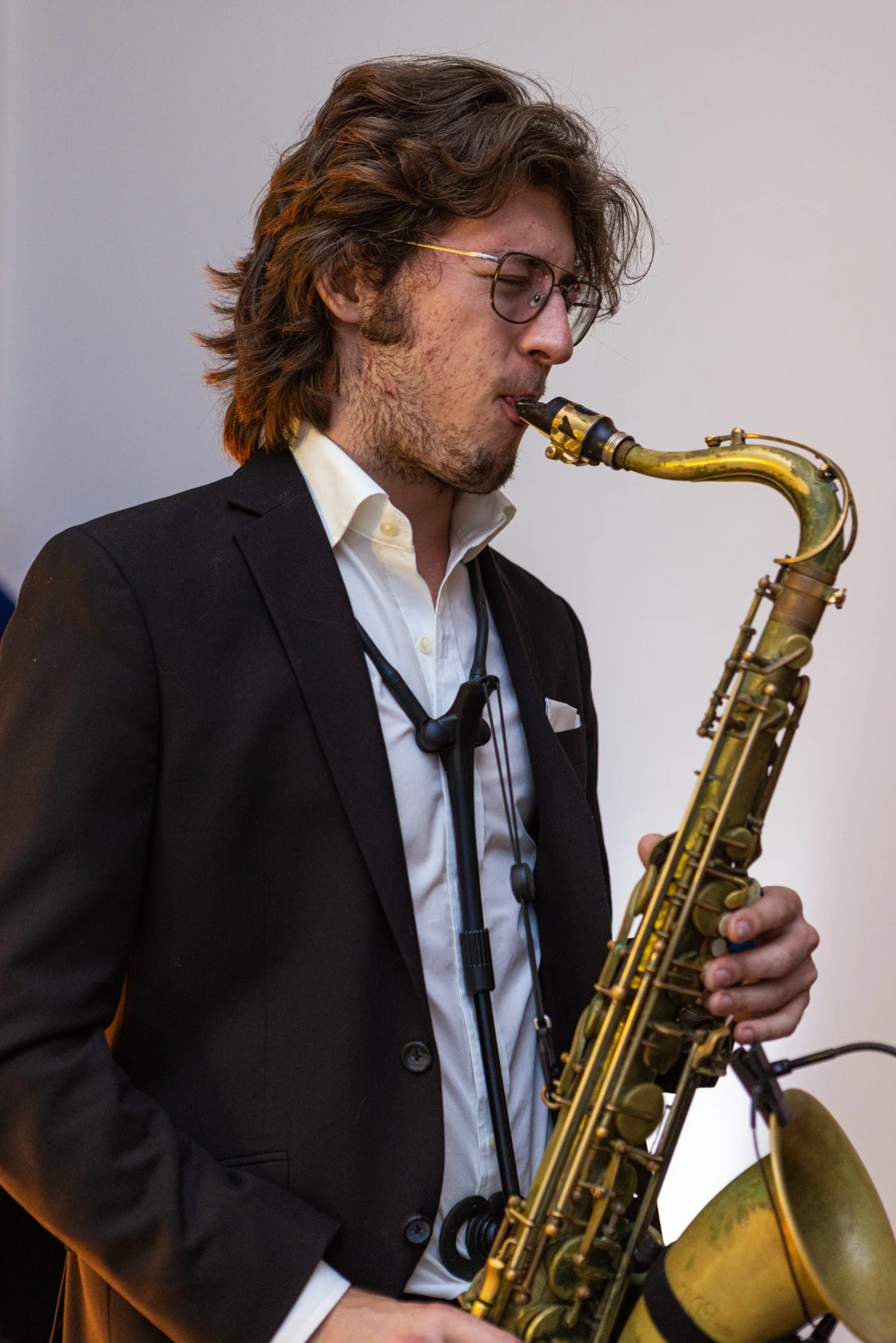 Formal saxophone performer in a tailored suit, ideal for high-end event entertainment and elegant corporate functions. Located in Florida