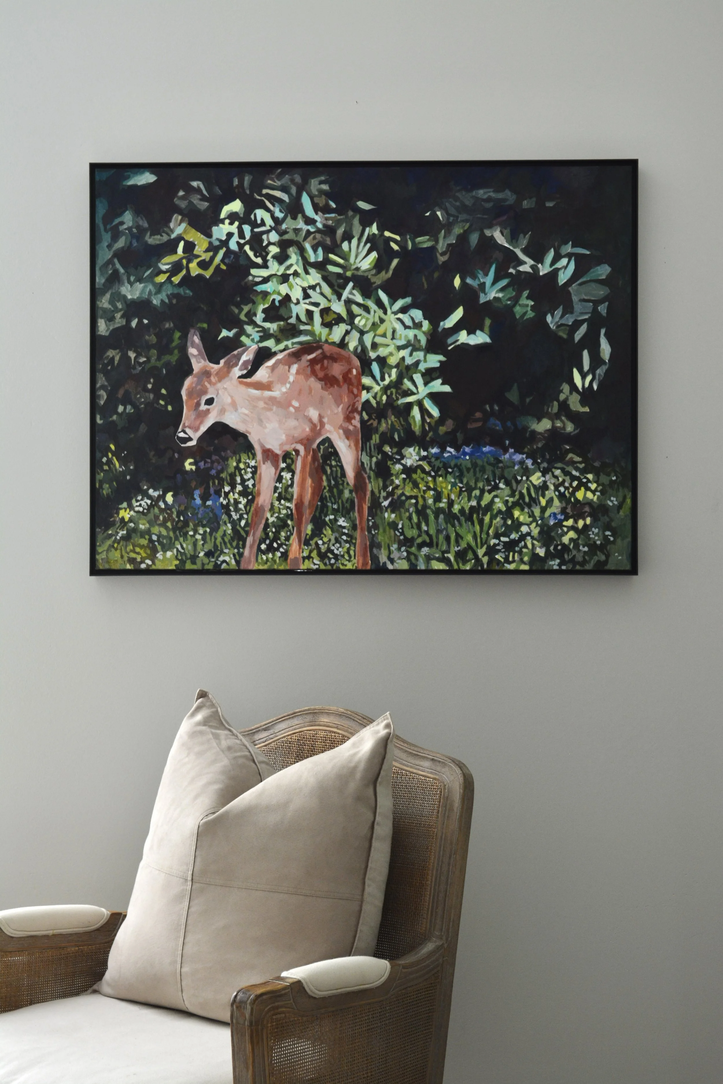 Painting of a young deer standing outdoors among trees and grass, with dark and green foliage in the background.