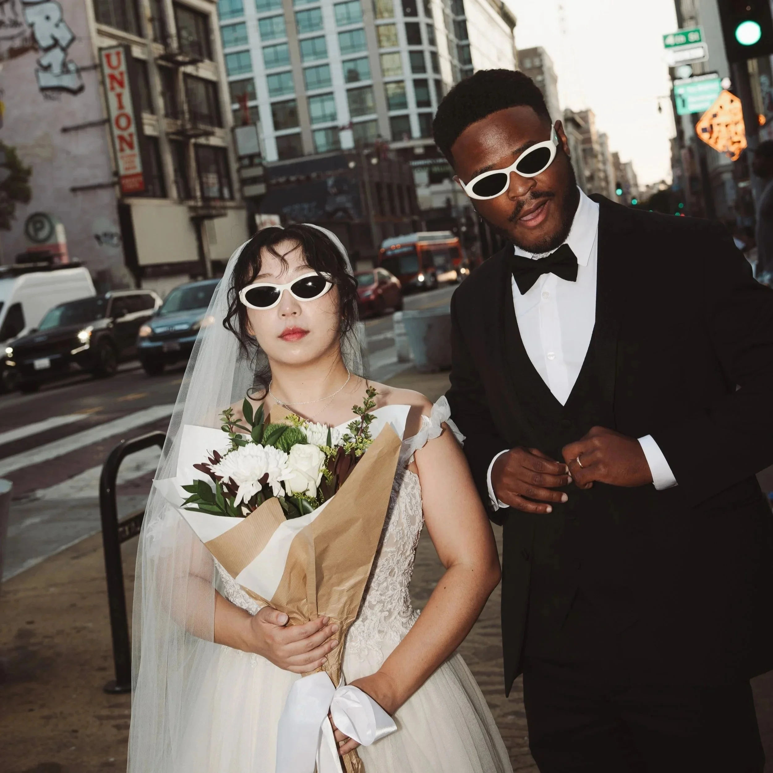 Stylish downtown Los Angeles wedding portrait of a couple in full wedding attire on a city street—editorial, modern, and candid with an urban backdrop.