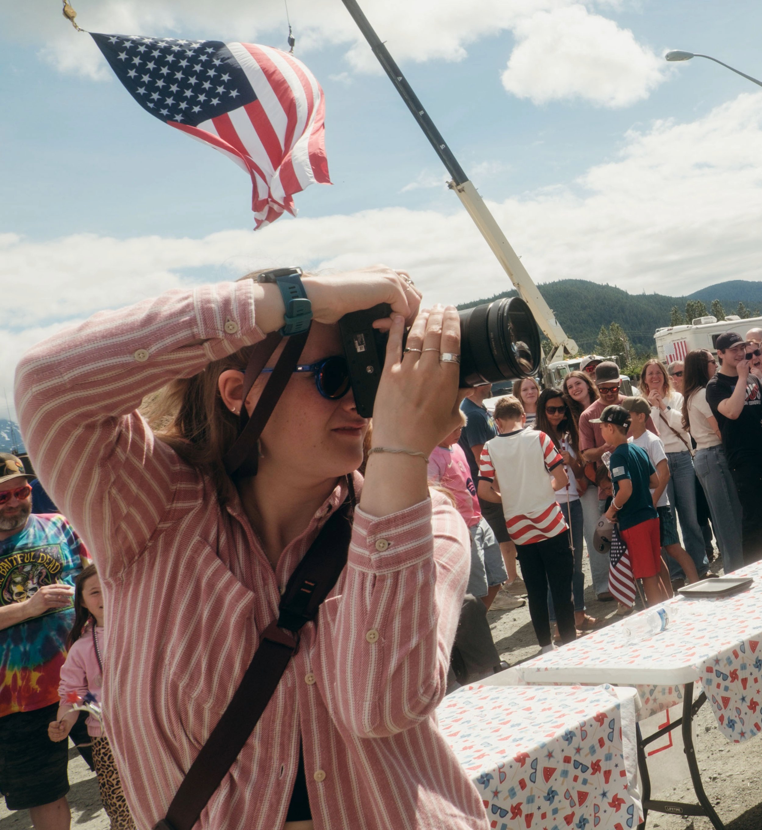 Intern Lizzy Hahn photographs a competitor of a hot dog eating contest during Haines' July 4th celebration in 2026.