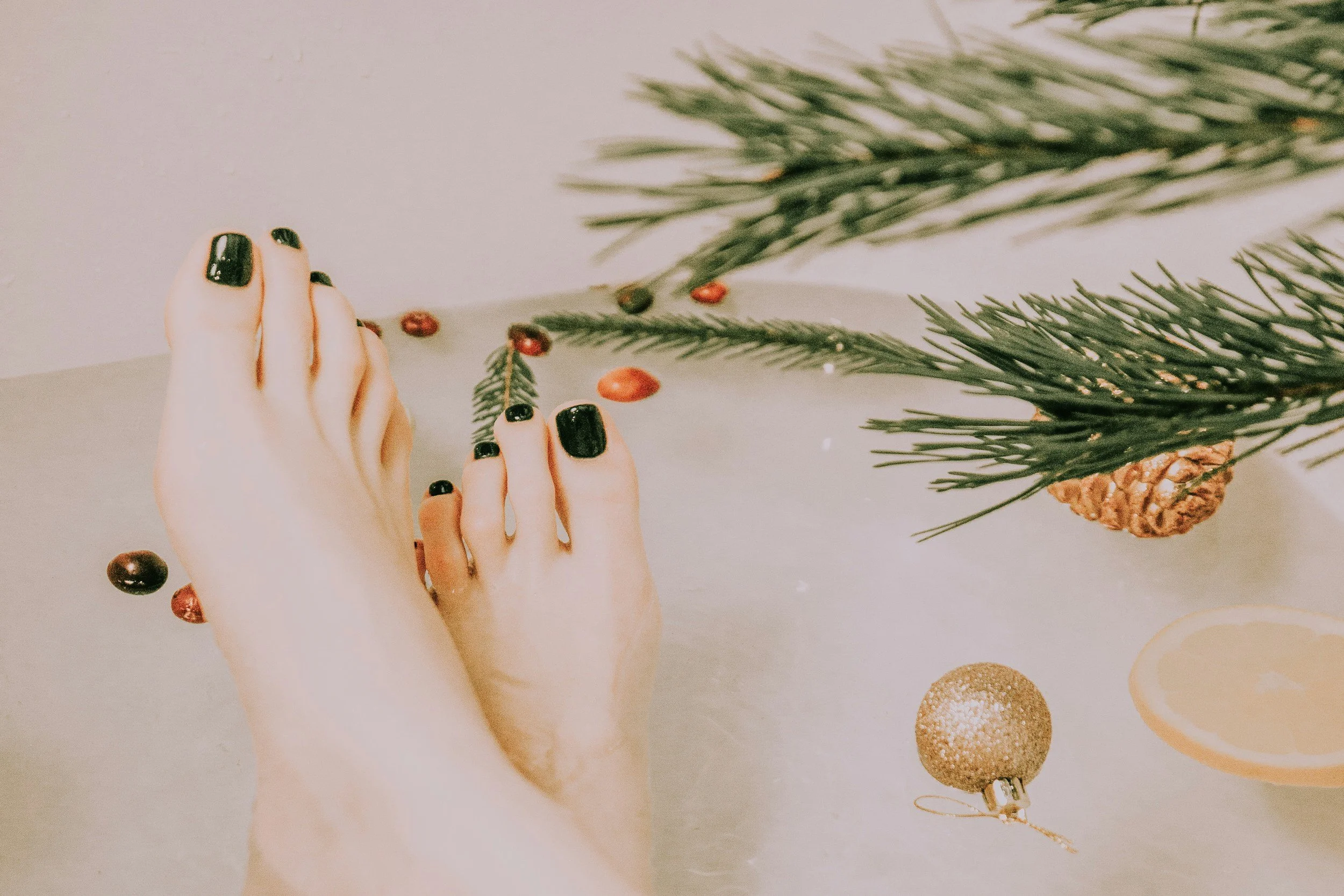 woman feet by Christmas tree
