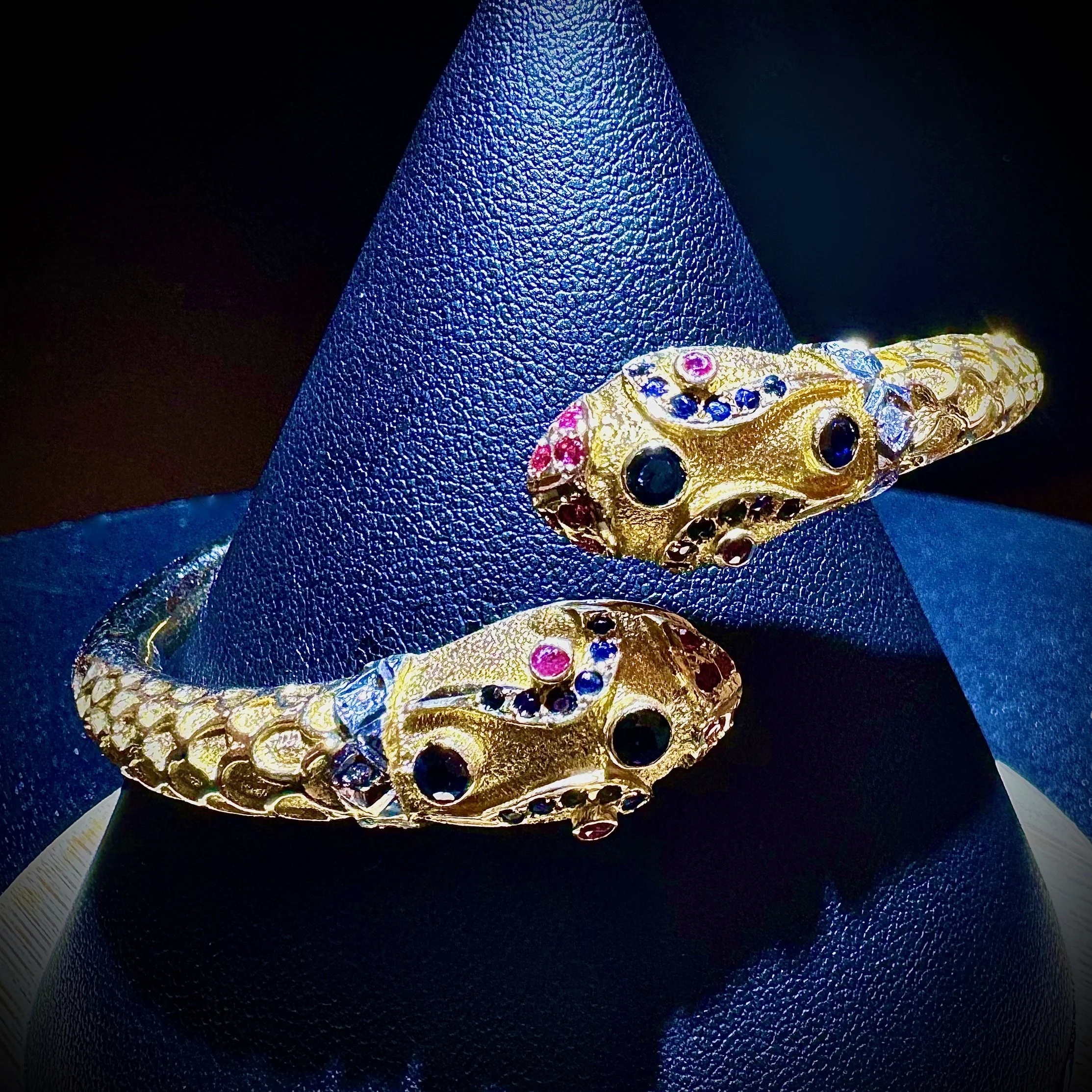A made to order 18k yellow gold sapphire and diamond bangle created by Eseis.