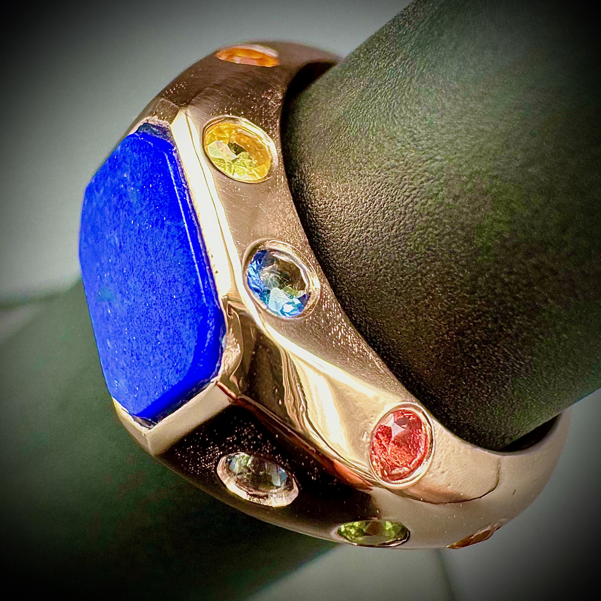 A custom made yellow gold ring set with lapis lazuli and sapphires. Statement ring is an example of the fine detail and workmanship Eseis manufactures