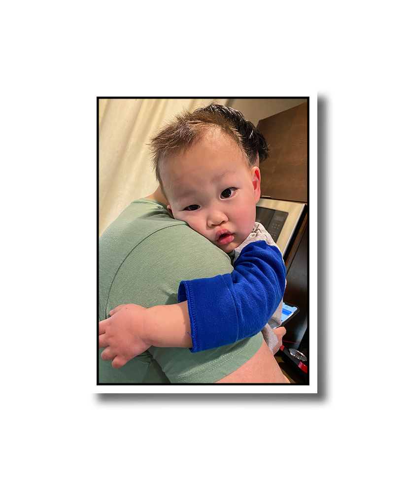 A young Noah relaxing on his dad's shoulder