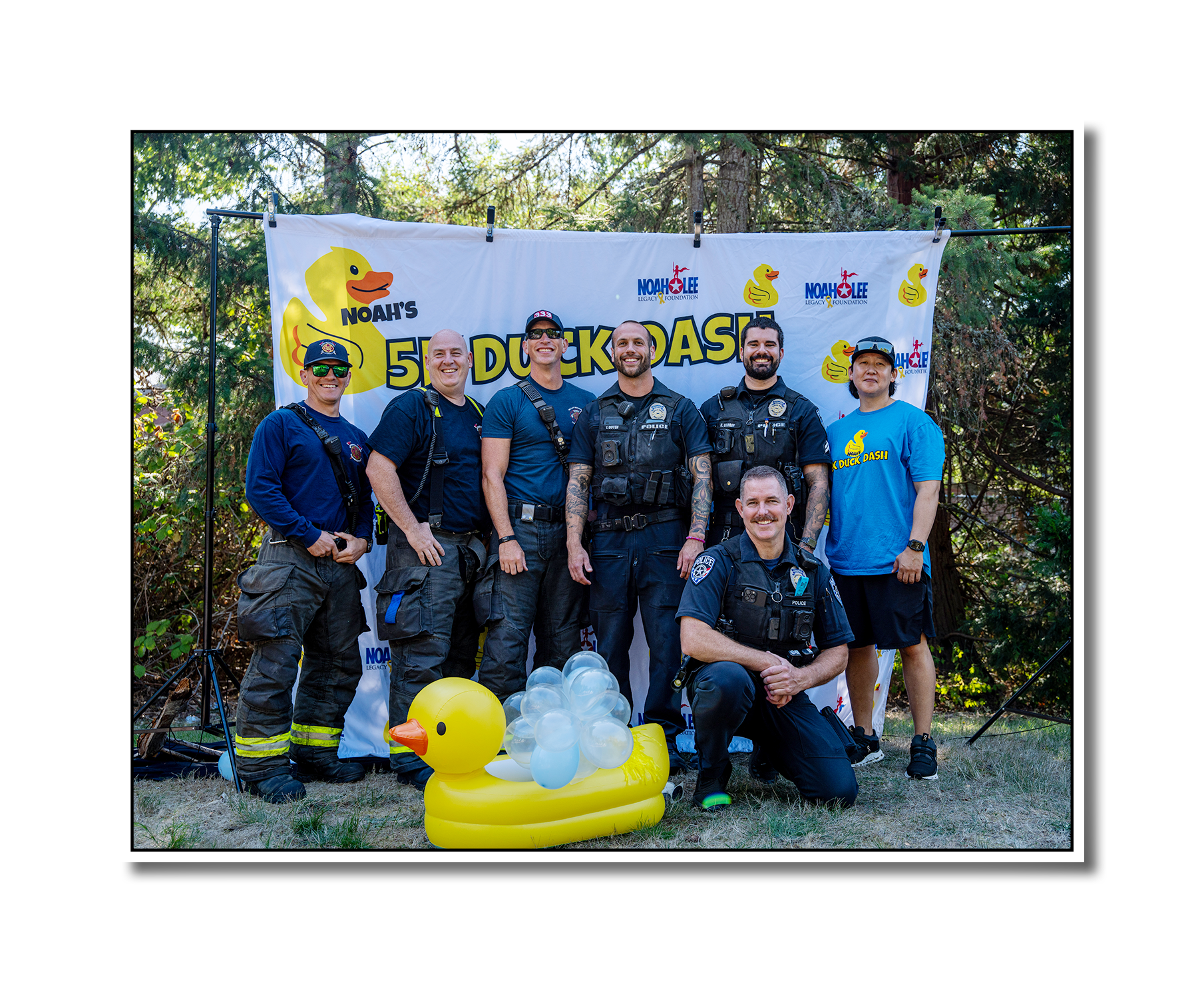 Photo of men from local Police and Fire departments during the 2025 5k Duck Dash.