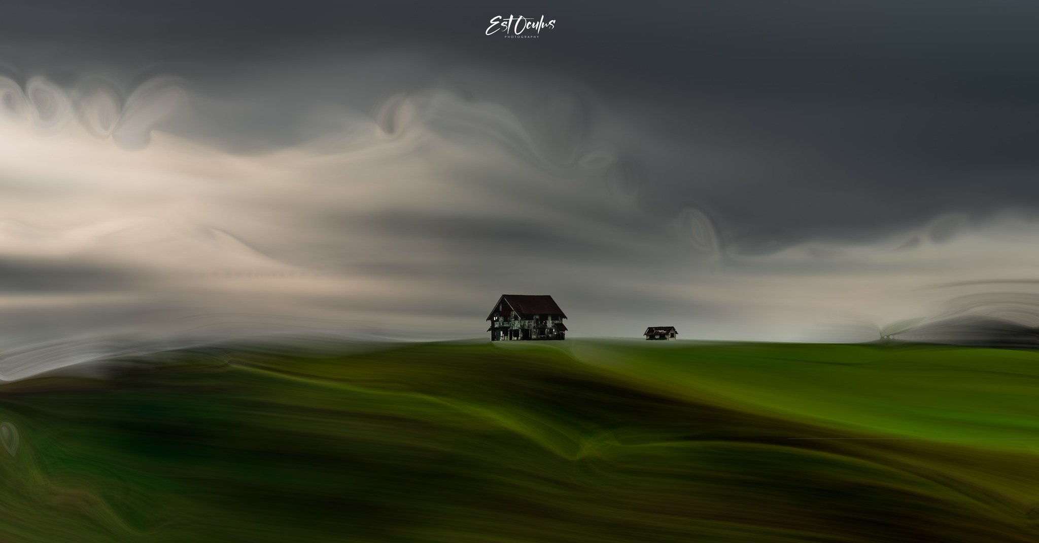 Surreal landscape with blurry green hills, cloudy sky, and a house in the distance.