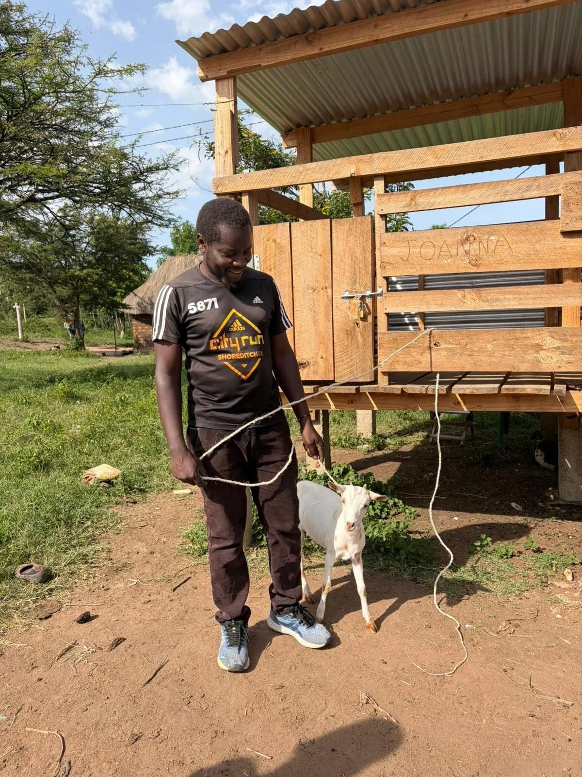 🐐🌅 Small Moments, Big Impact

Two snapshots of Go MAD life in Tanzania.

First, Freddy handing over a goat from one of the goat sheds built by volunteers over the summer &mdash; a simple moment that represents long-term livelihood, security and dig