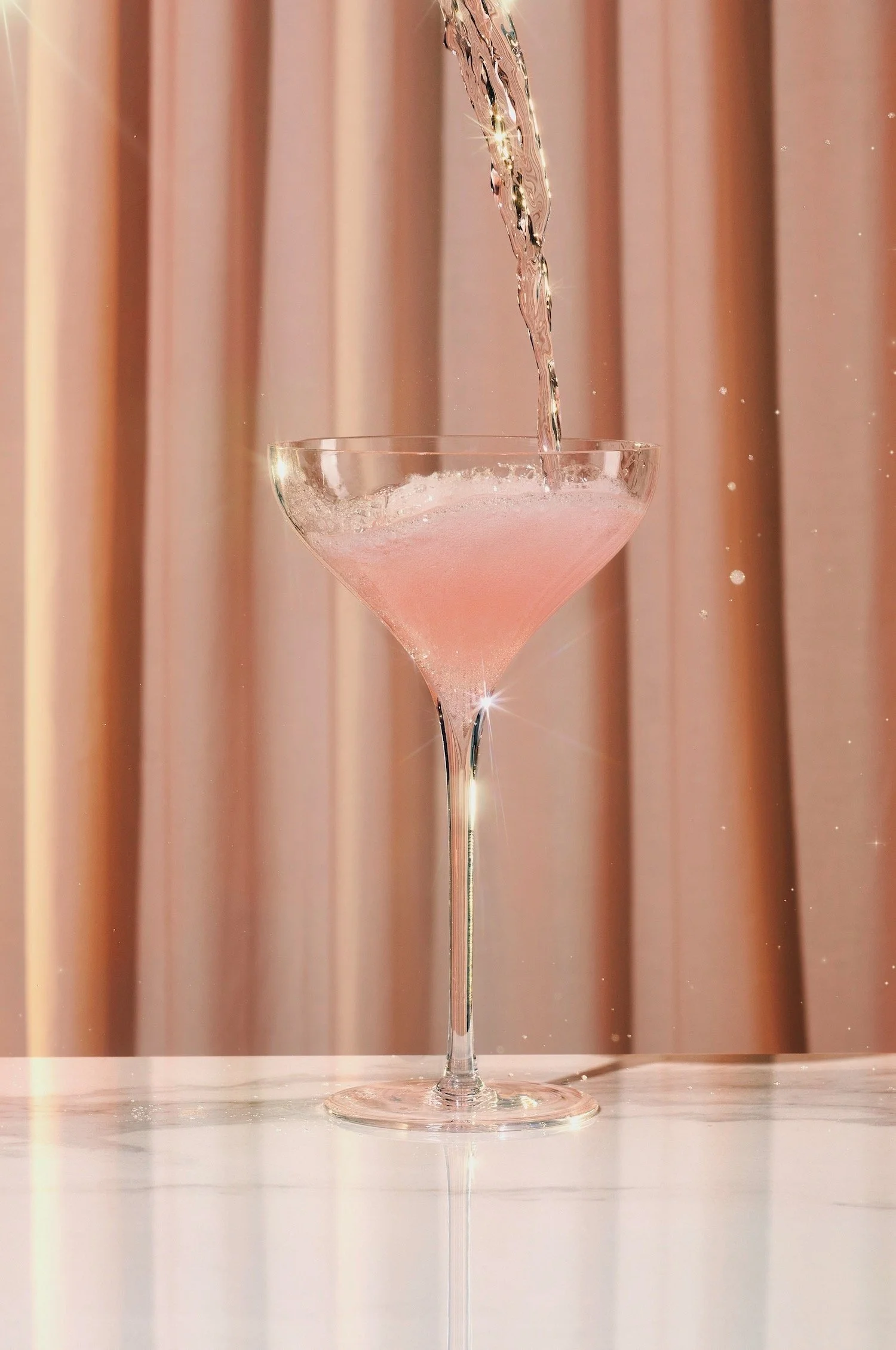 Pink prosecco pour with a vintage style background, drinks and beverages photographer Frankie Turner