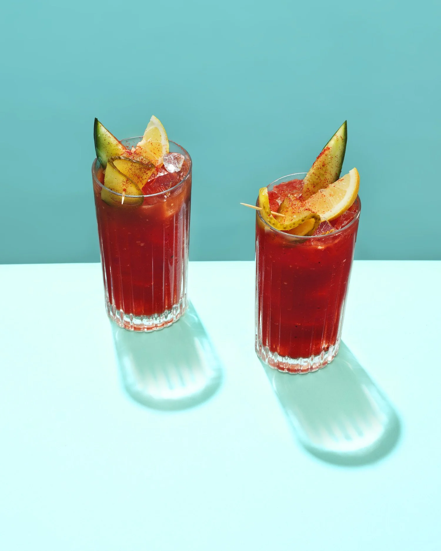 Two beautifully garnished glasses of bloody mary, bold and colourful drinks photography by Frankie Turner