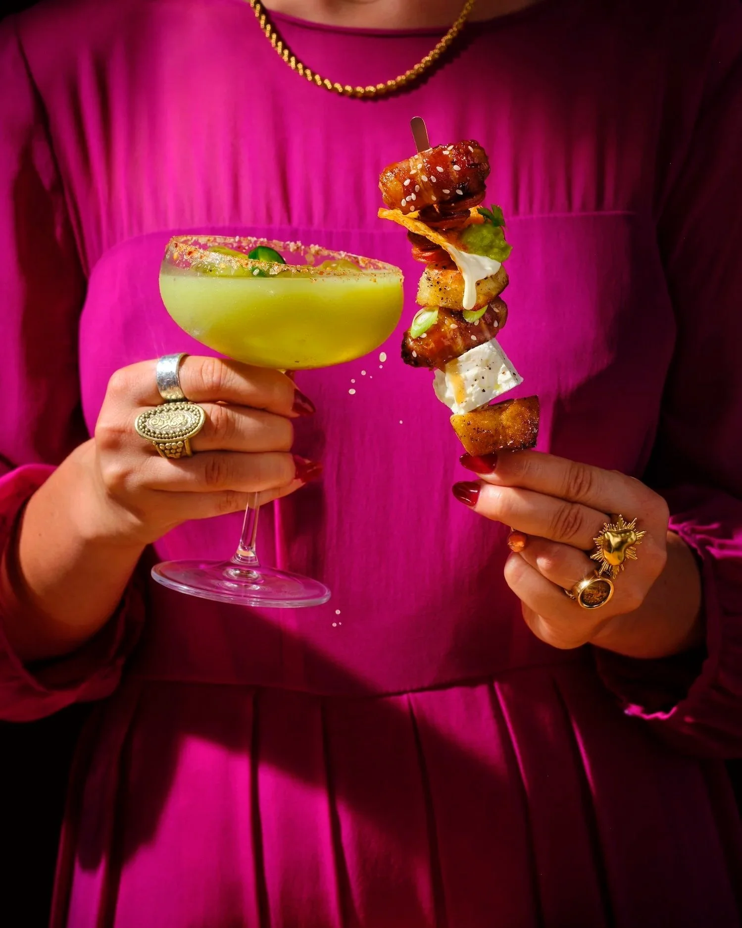 Frankie Turner's bright and colourful image of a lady in a fuschia dress holding a spicy margarita and seasonal skewer for Waitrose