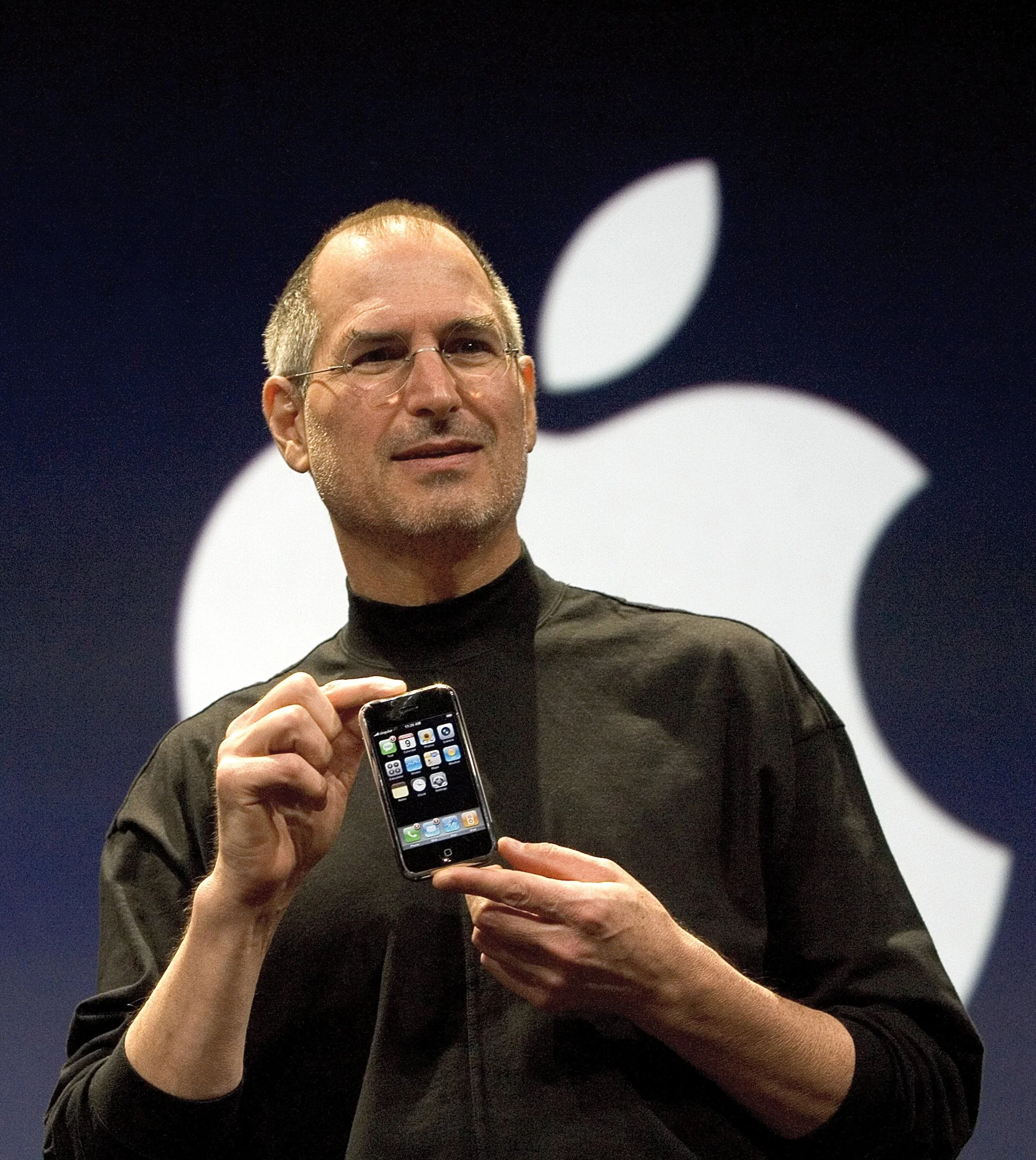 Steve Jobs presenting the first iPhone on stage in 2007.