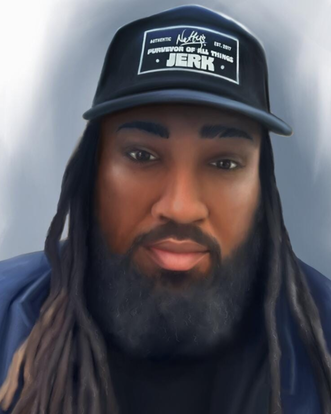 Close-up of a man with long dreadlocks and a beard wearing a black baseball cap with white text and graphics.