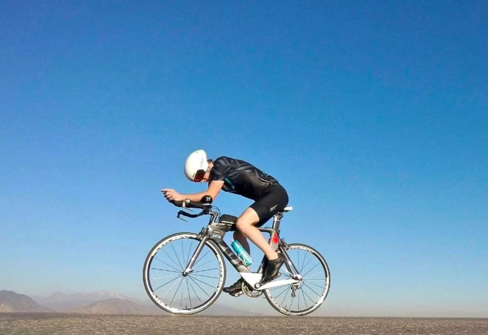 Triathlete cycling in an aerodynamic position during Zone 2 endurance training.