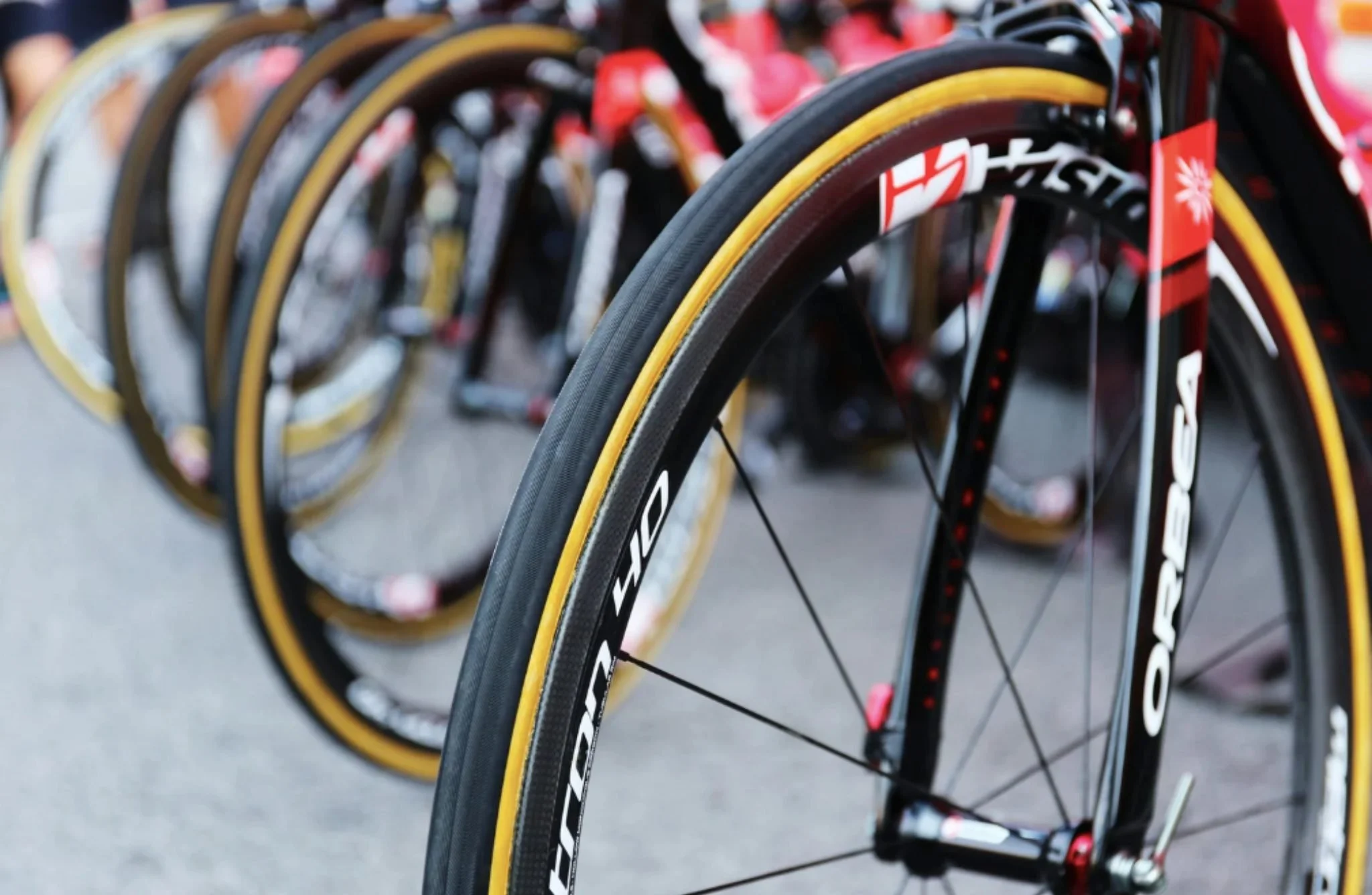 Cycling race wheels lined up before a race, representing overthinking training decisions and the need for certainty.