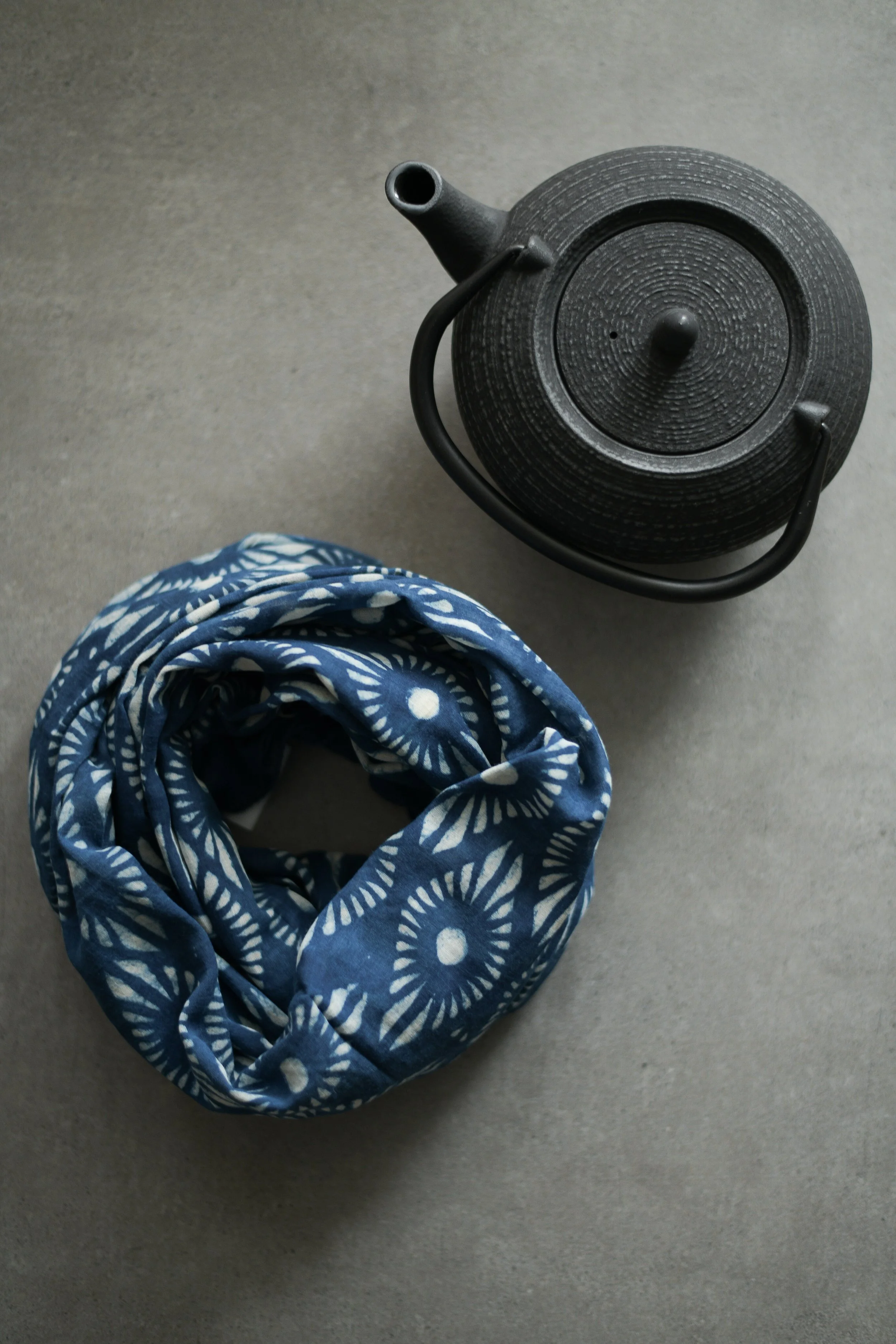 Hand block printed indigo cloth with a repeating geometric design printed by Lizane Louw in the Dabu tradition in Bagru, Rajasthan.
