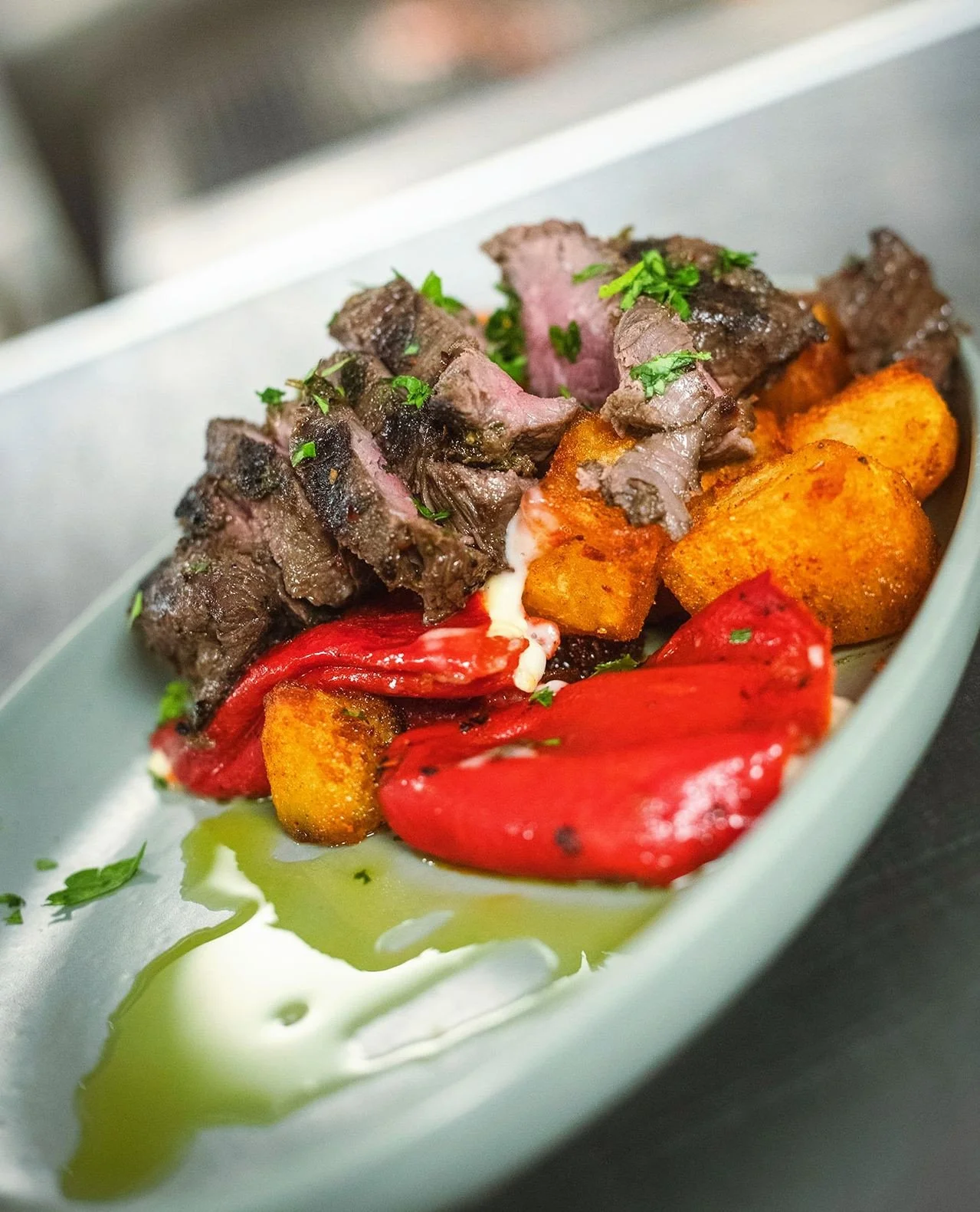 Our Chermoula Marinated Hanger Steak brings bold Mediterranean flavor to the table&mdash;perfectly grilled Brandt hanger steak served with manchego-stuffed piquillo peppers and crispy papas bravas. Pair it with a glass of wine, a few meze to share, a