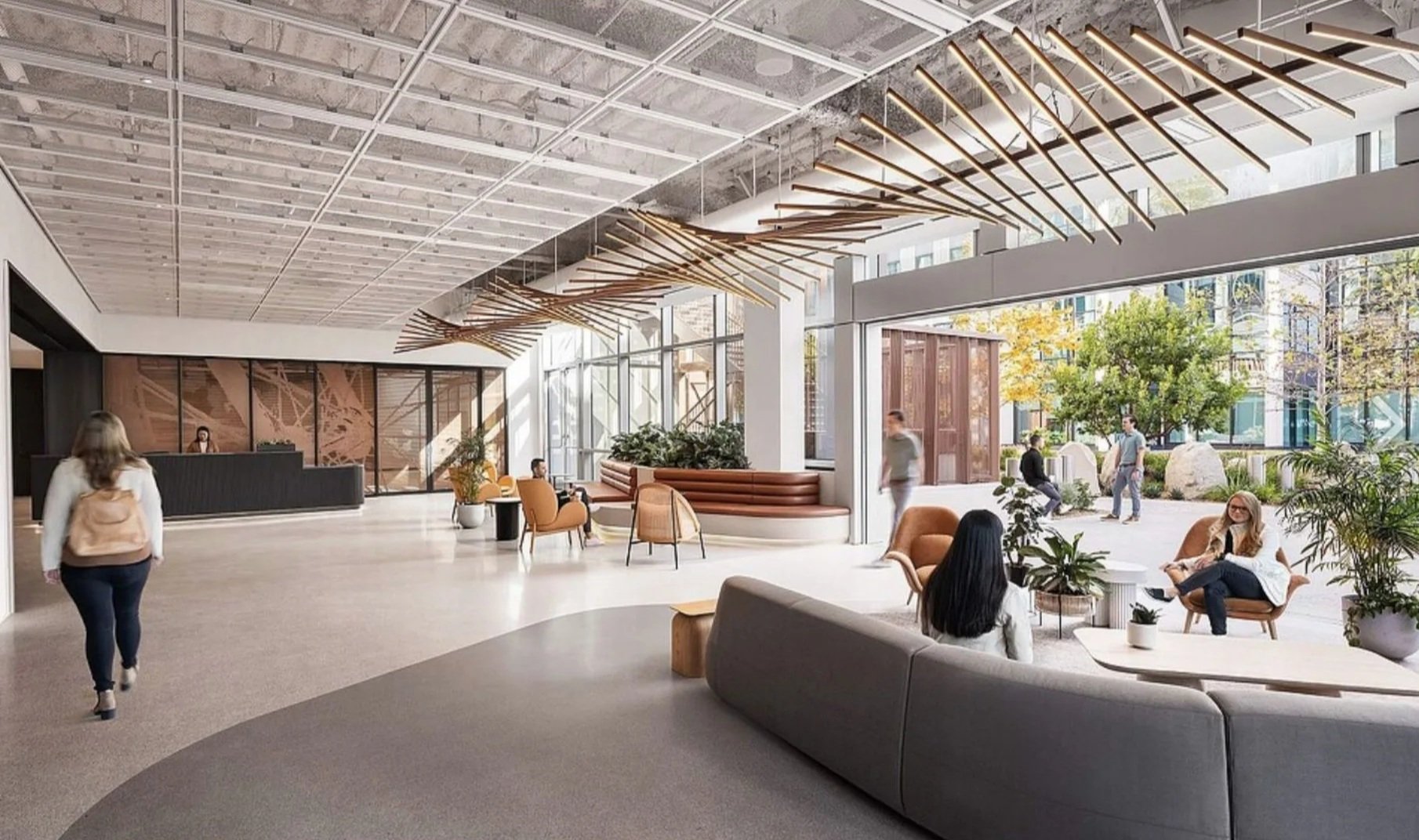 Modern hotel lobby with seating area, reception desk, large windows, and hanging wooden art installation