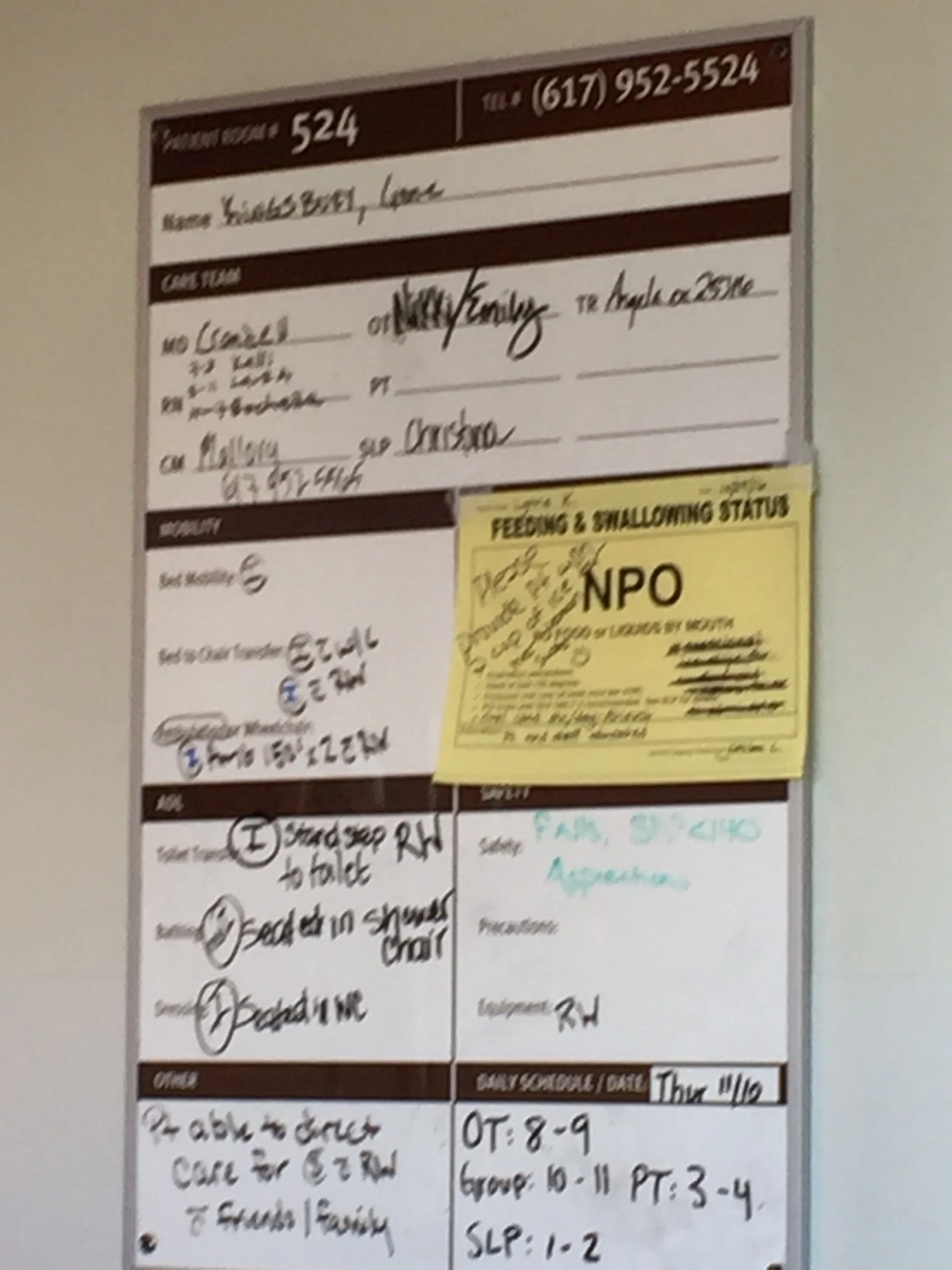 A picture of my medical board in rehab, prominently displaying NPO, I could not swallow, even my own saliva. 