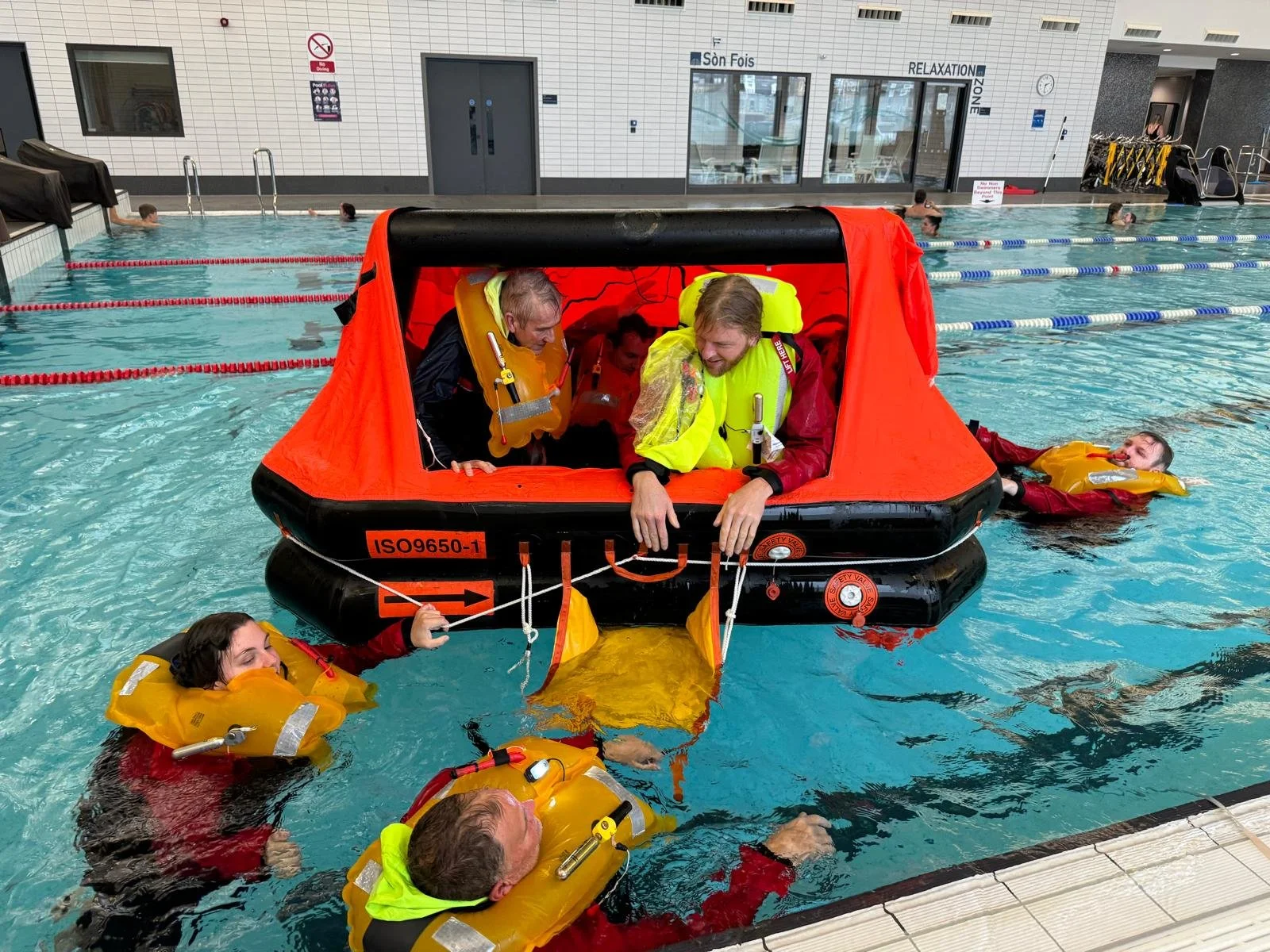 Students in a swimming pool on the sea survival course