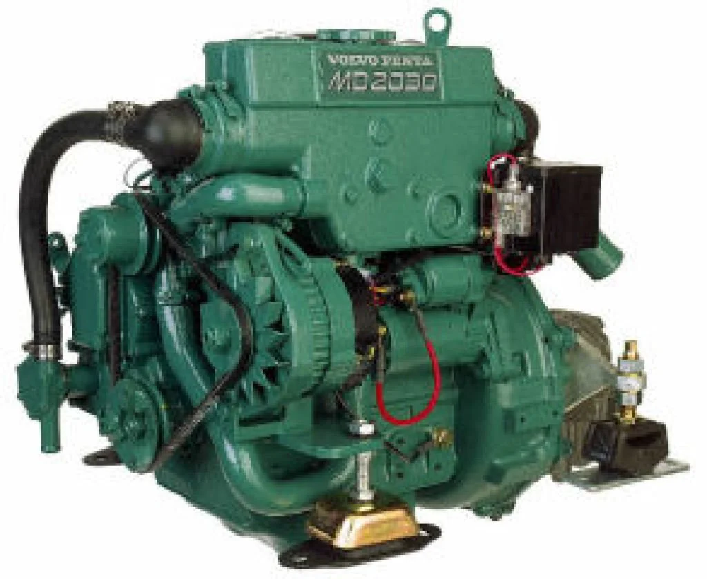 A large green industrial engine with various pipes, wires, and components.