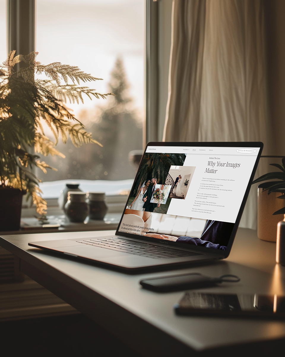 Laptop open on a desk displaying a webpage designed by Bear Design Company titled 'Why Your Images Matter,' with potted plants on either side and a window with curtains behind, showing a blurry outdoor scene with trees.