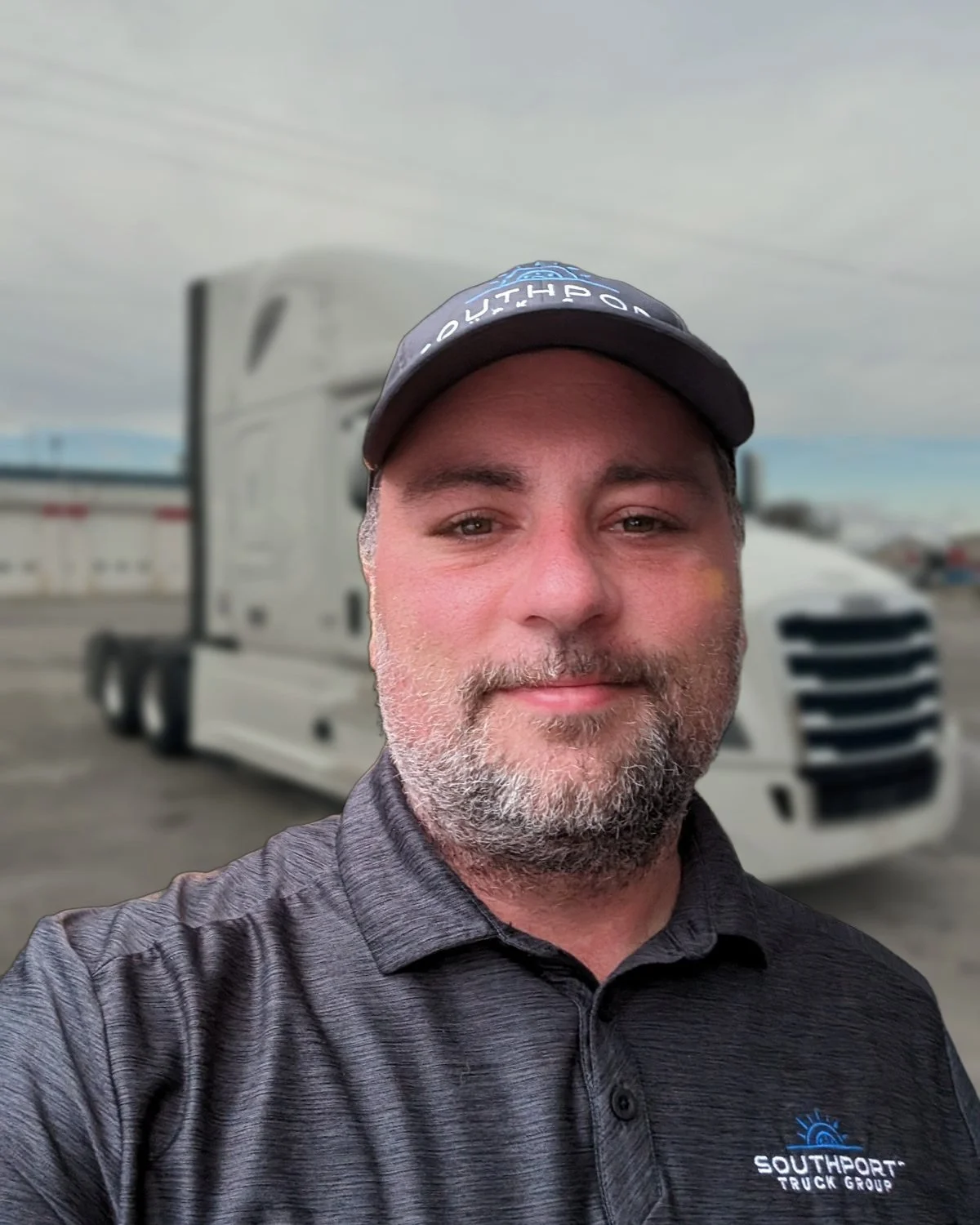 Paul Drake, owner of Drake Truck Source, in front of a white Freightliner Cascadia