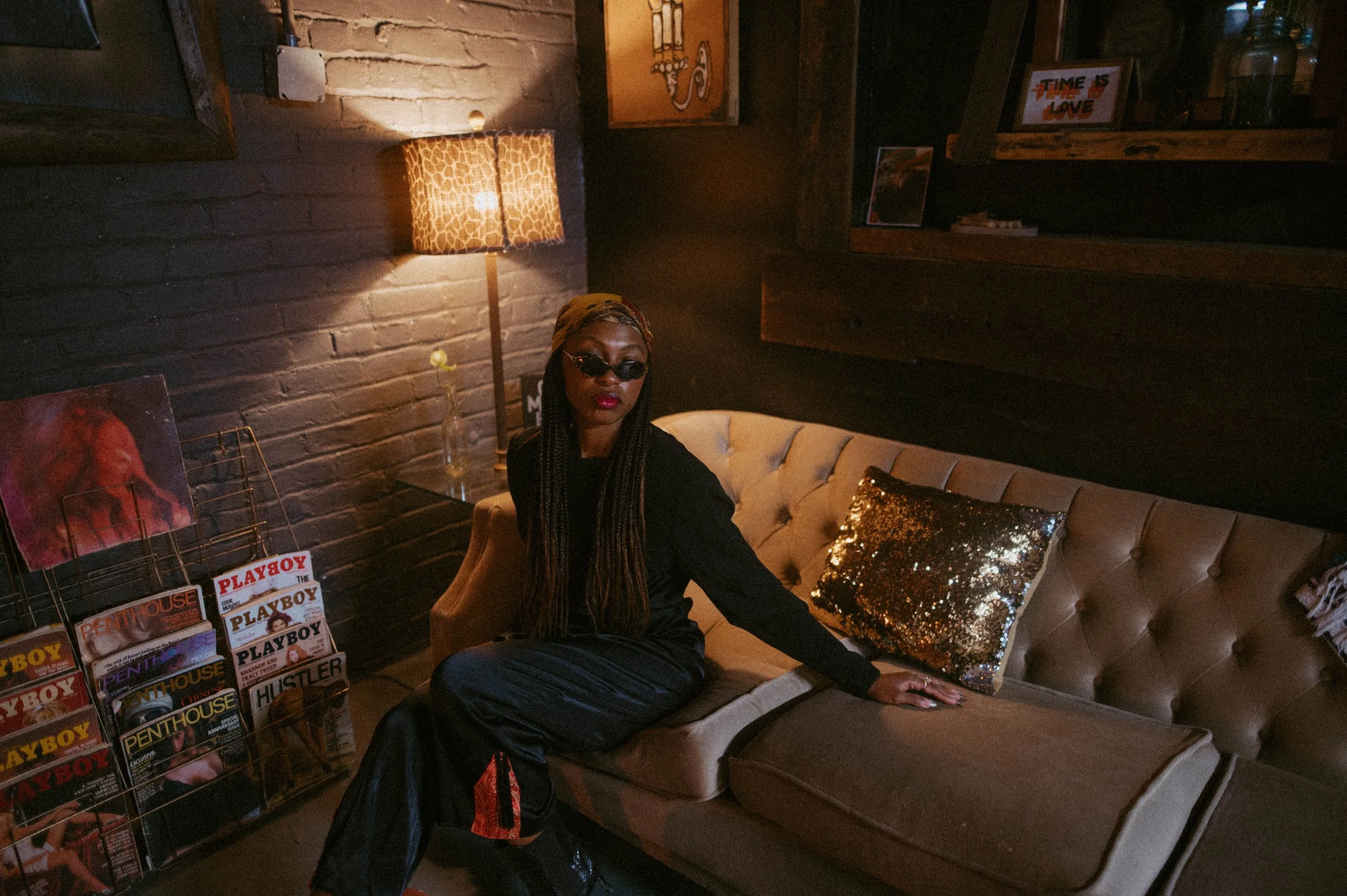 Katana Williams, co-founder and CEO of Fashion To The People, photographed in a warm, vintage setting that reflects the brand’s roots in culture, history, and intentional fashion.