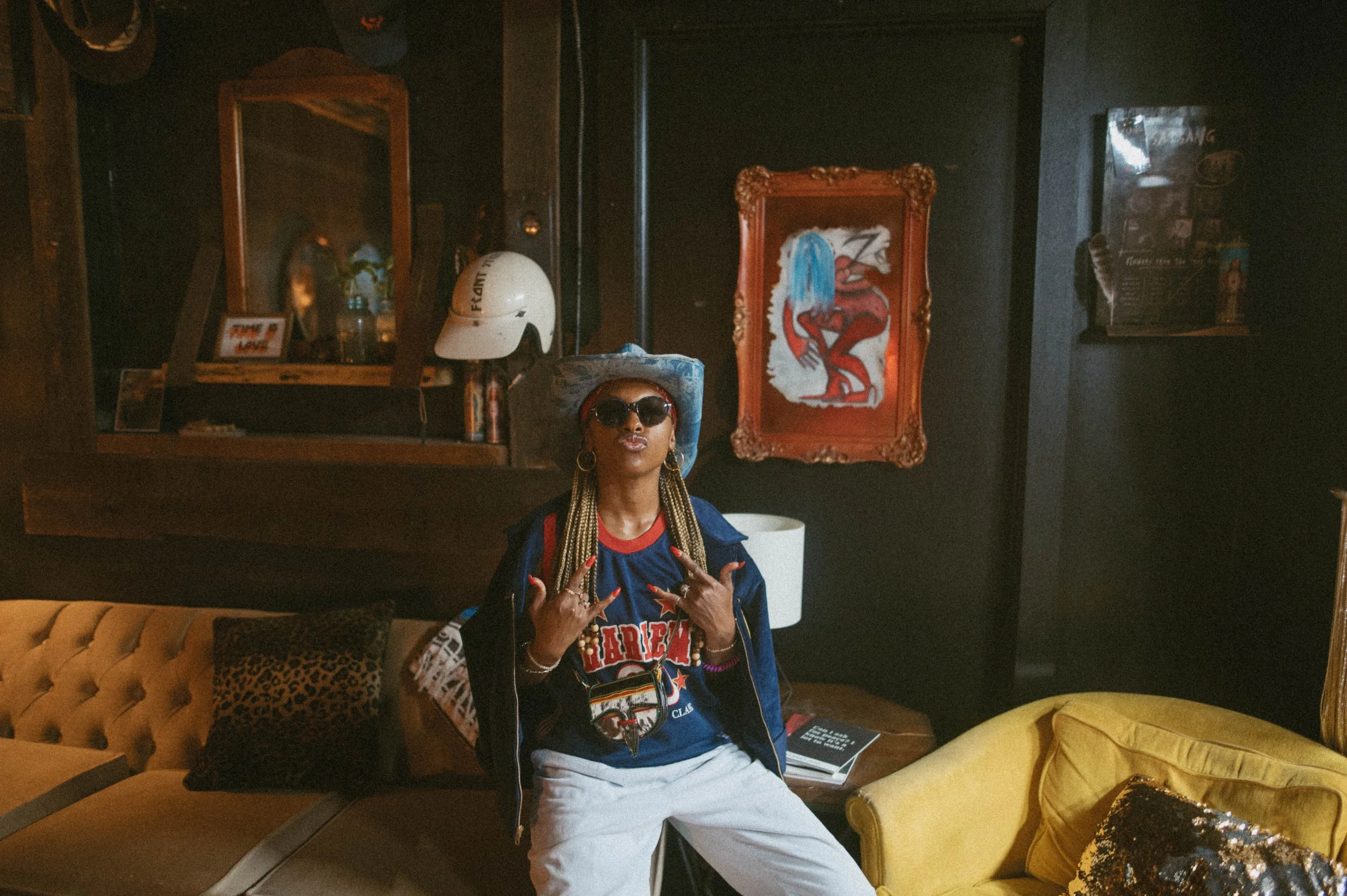 Kyetra Williams, co-founder of Fashion To The People, photographed in a curated vintage setting that reflects the brand’s roots in streetwear, culture, and storytelling