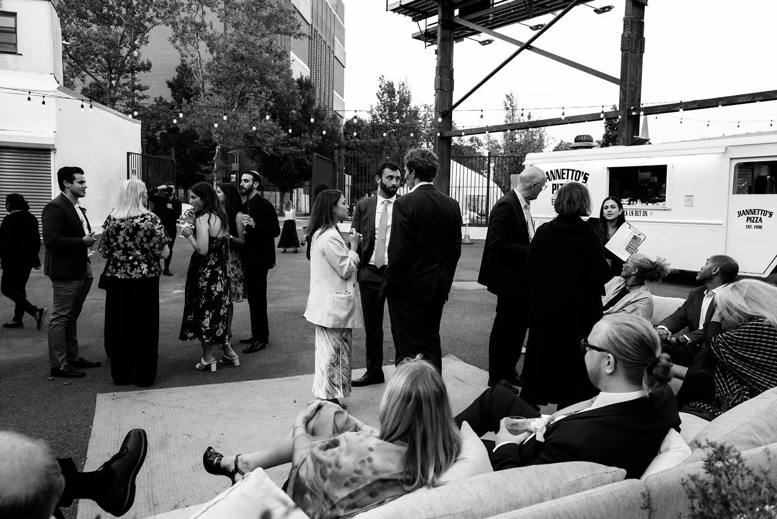 Couple standing beside a courtyard food truck during their celebration.
