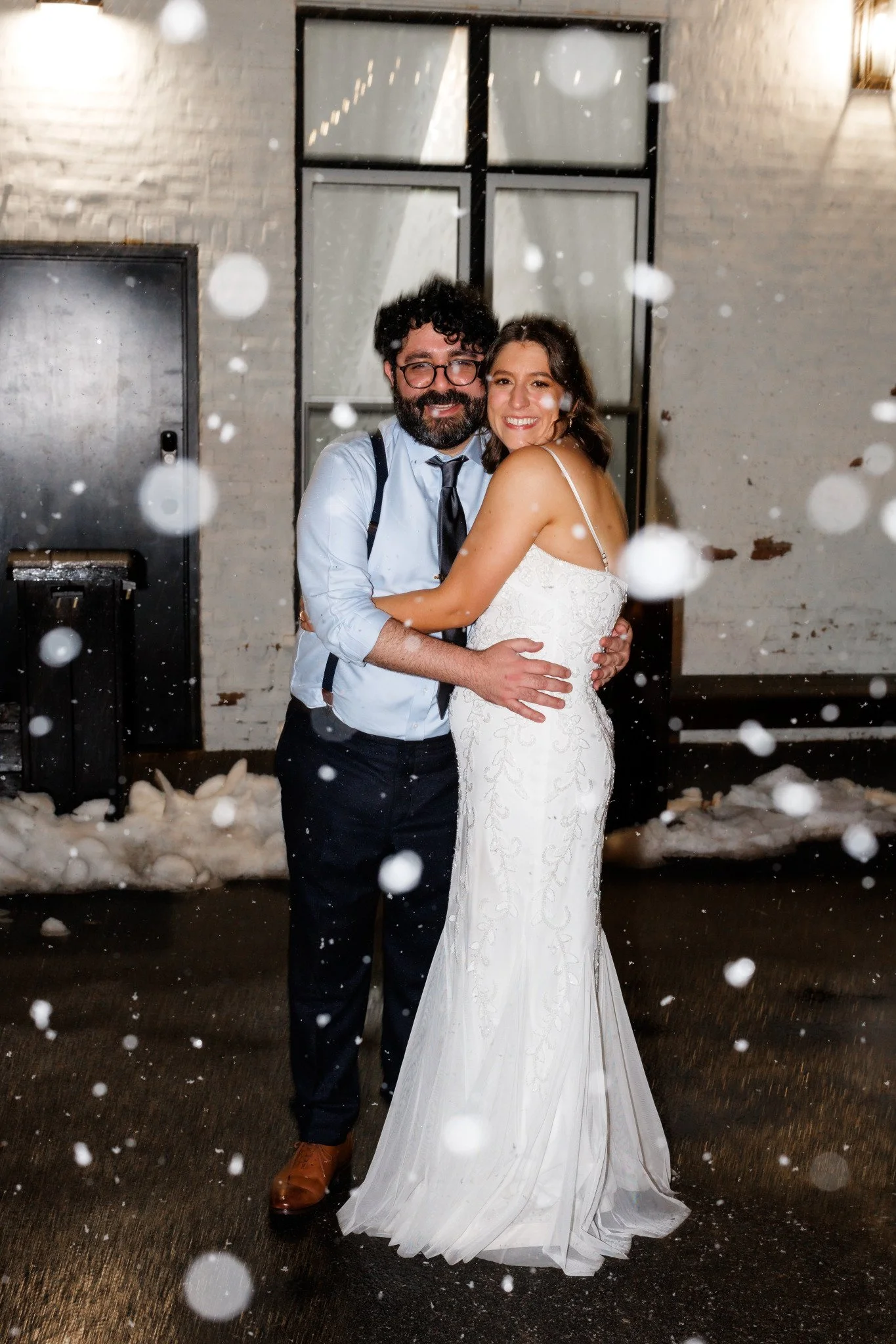 Beautiful couple taking snow photos in the courtyard