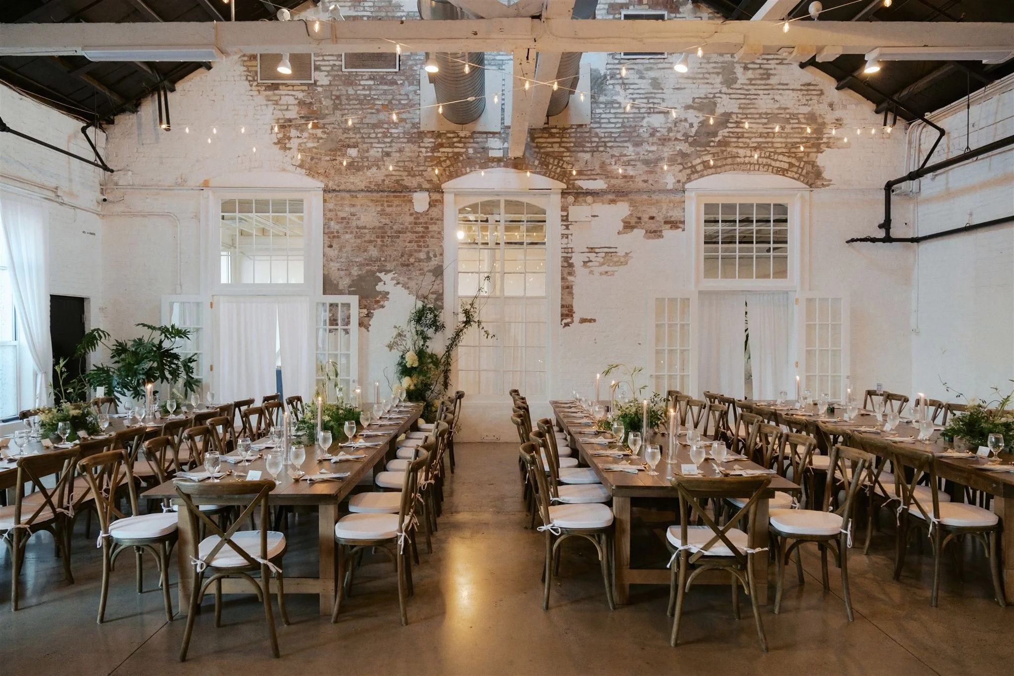 Wide-angle interior shot of the loft set for a ceremony or reception.

