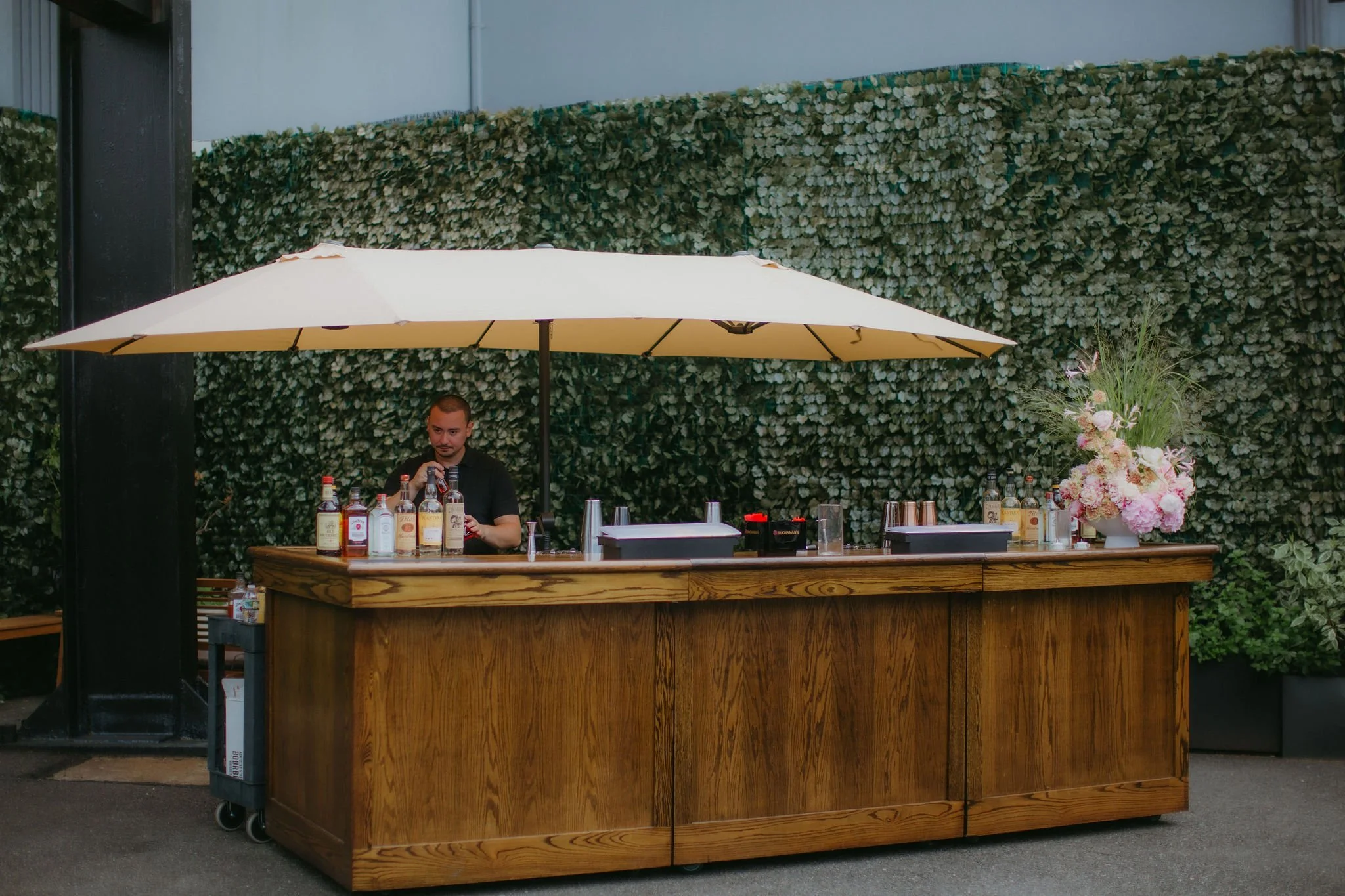 Courtyard bar setup with guests gathering 
