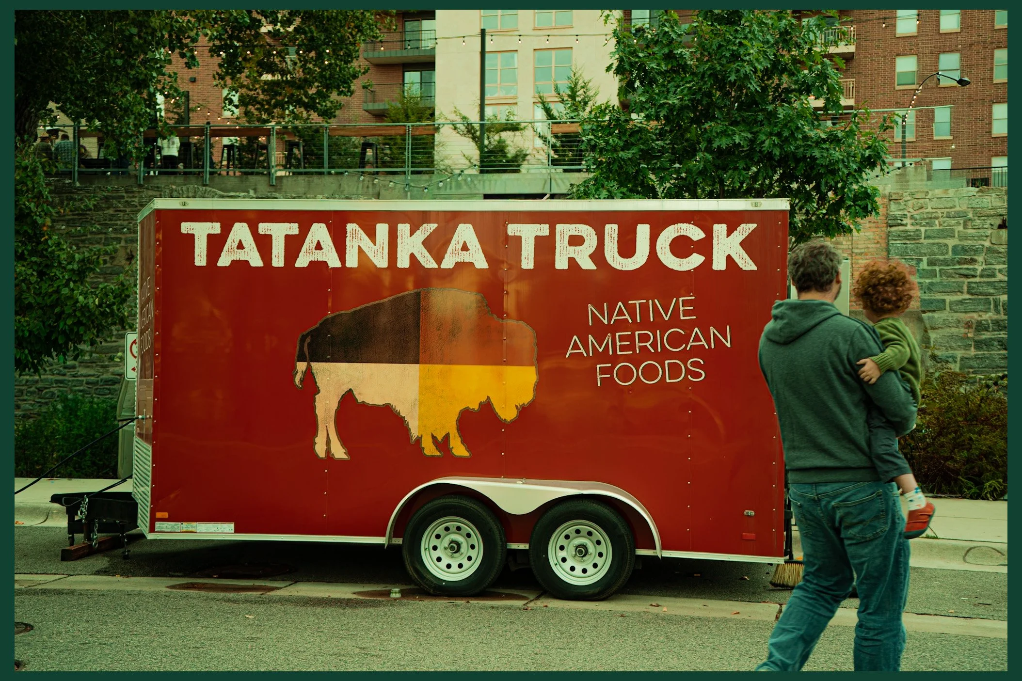Father and Son Walking Towards Native American Food Truck on a Summer Day in Minneapolis, 2024