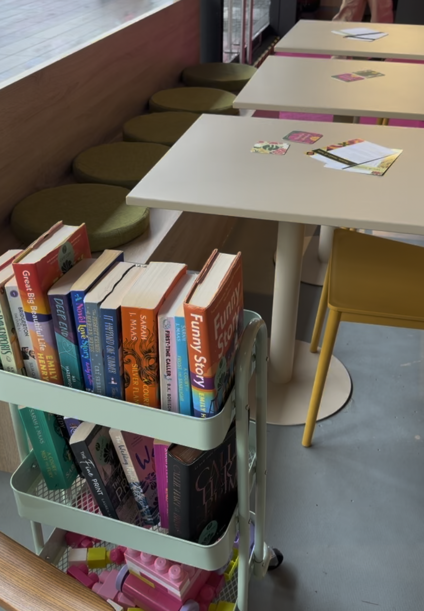 A library cart for browsing at the Main Character Books cafe