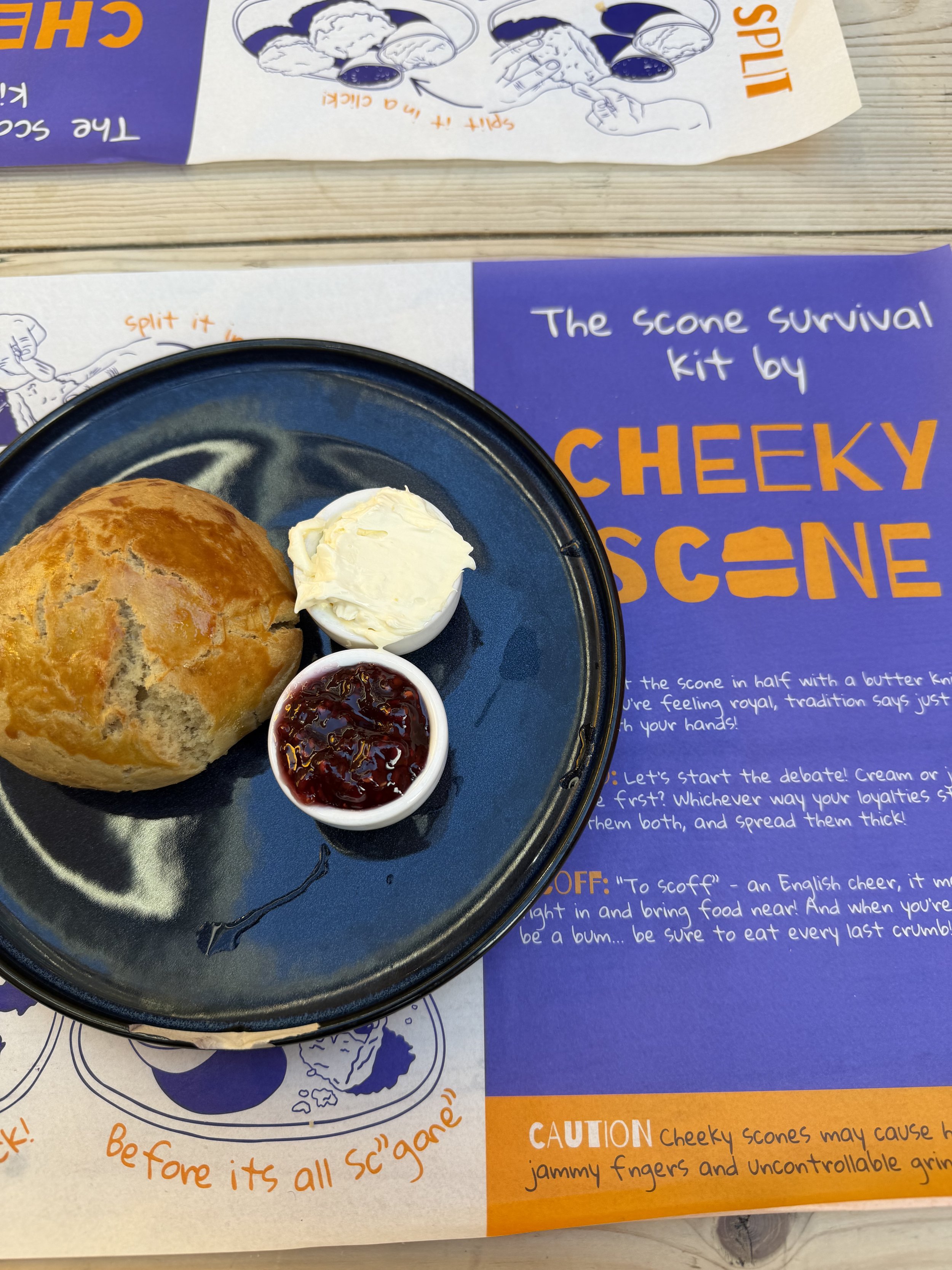 a plain scone from Cheeky Scone in London with clotted cream and raspberry jam