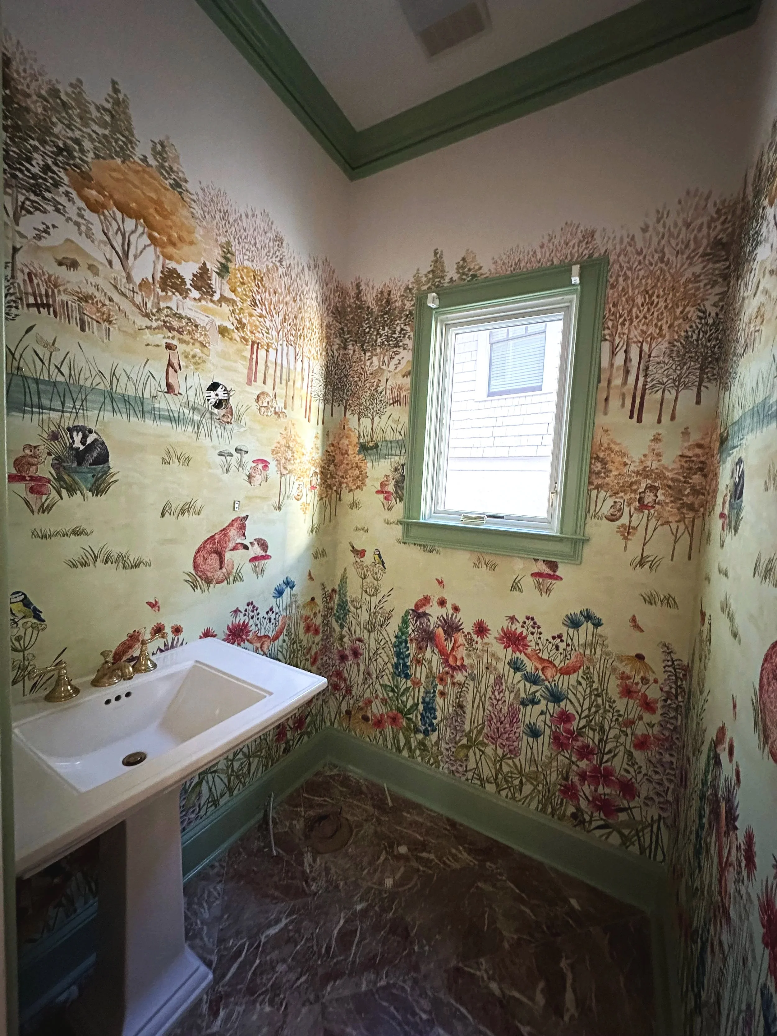 Small room with floral and animal wallpaper, a small white sink, green window trim, and marble floor.