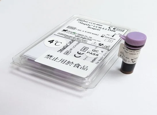 A travel medical test kit and a small vial with a purple cap on a white surface.